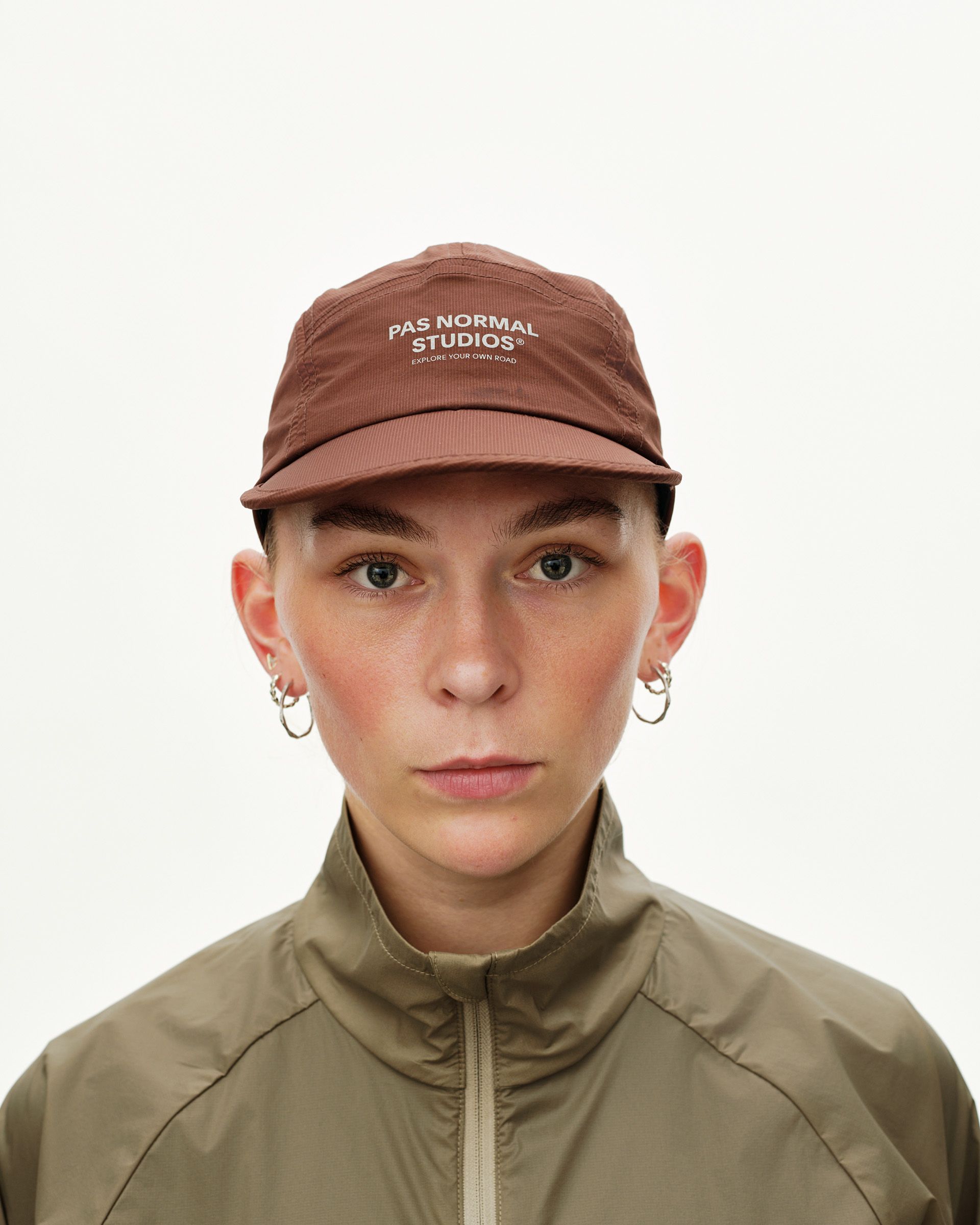 Maroon Brown Balance cap on model, front view with white logo print on crown