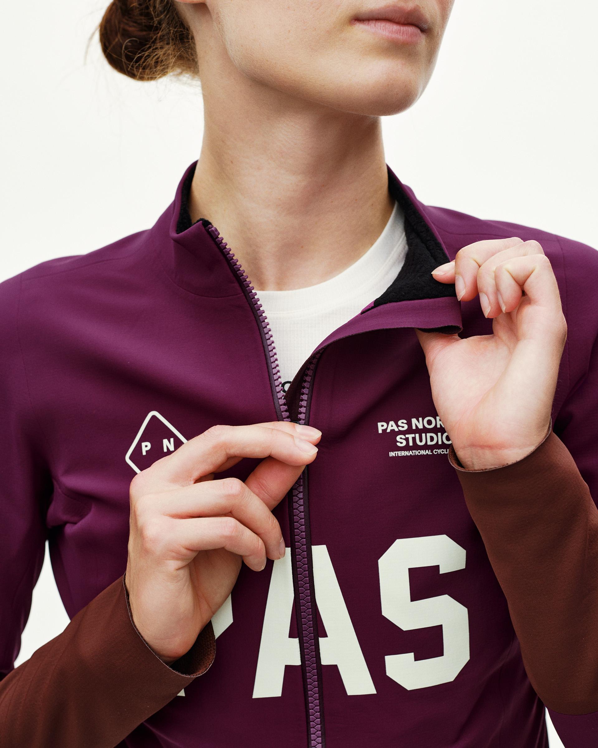 Dark Purple PAS Mechanism Thermal cycling jacket, front detail on model with large cream chest lettering and full zip