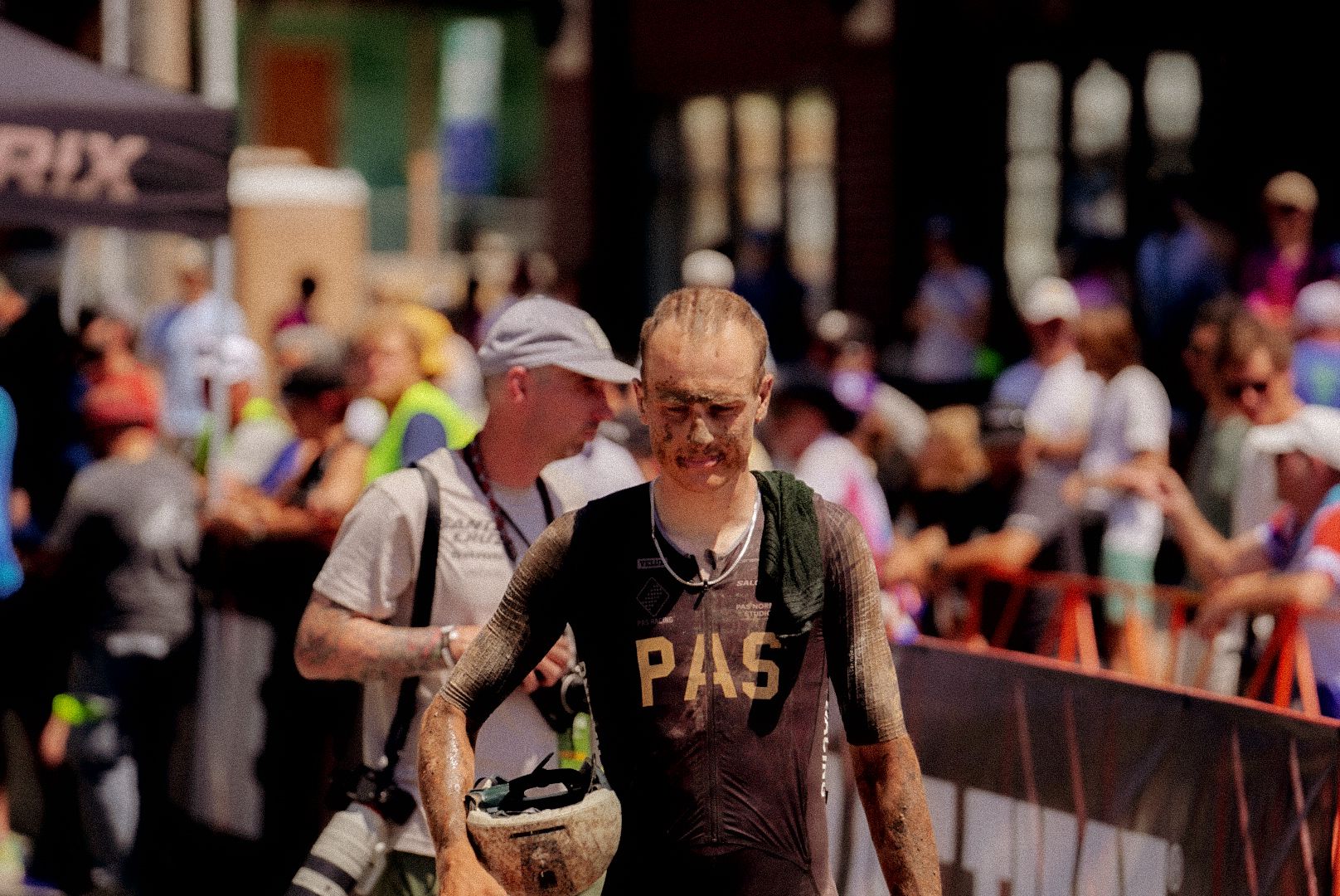 Triathlete wearing PAS tri suit emerging from water at race event