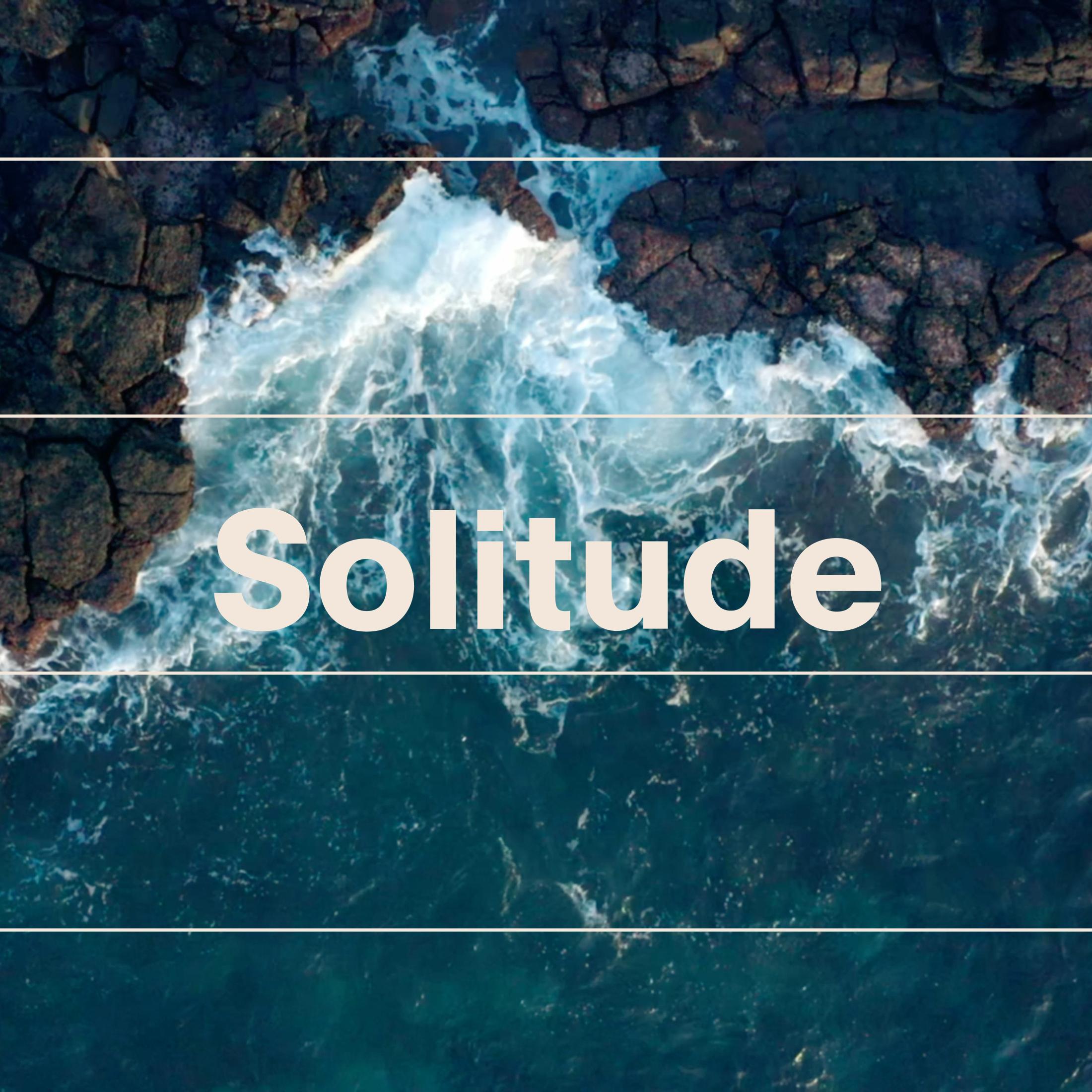 Aerial view of ocean waves crashing against rocky coastline with Solitude text overlay