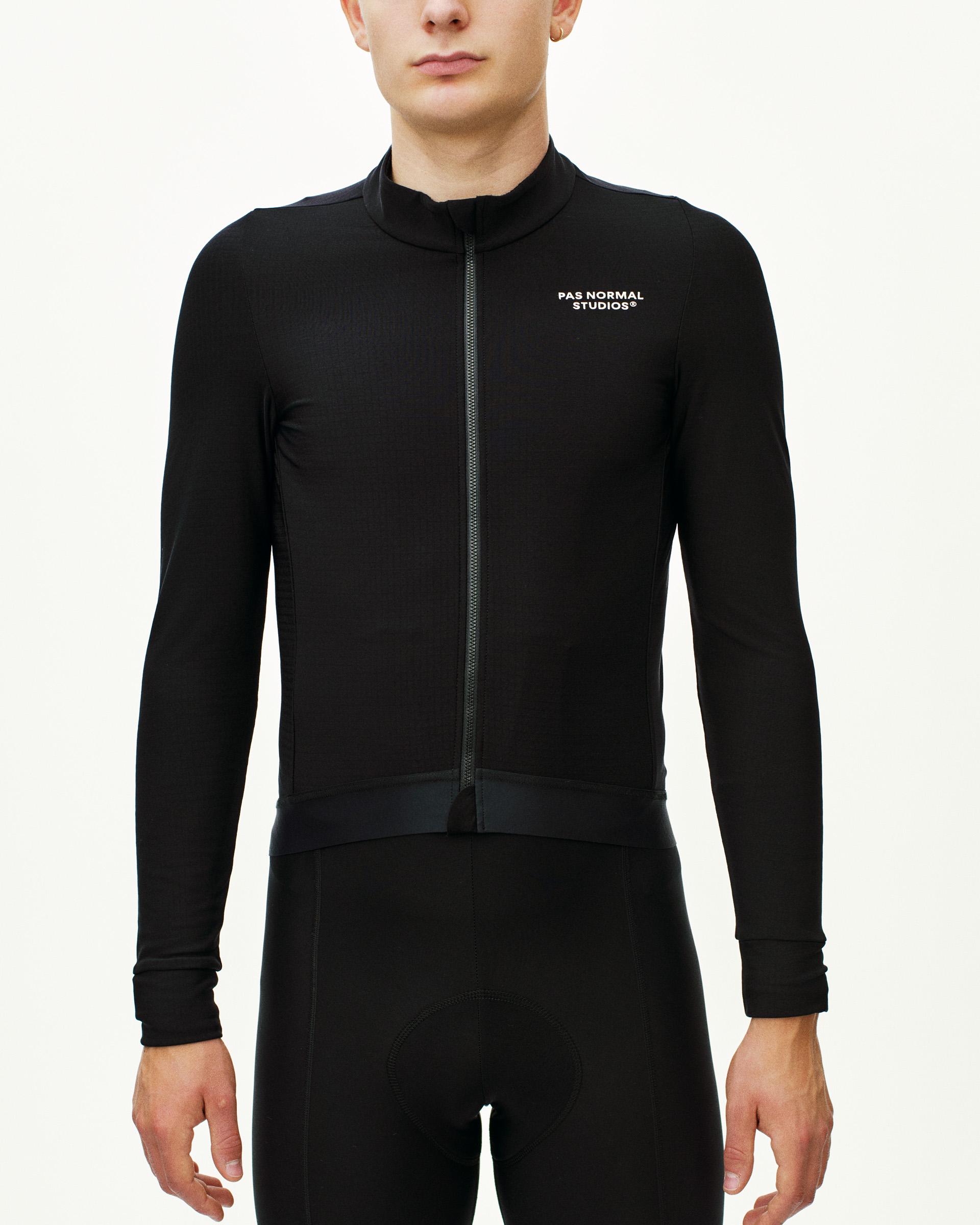 Black Essential long sleeve cycling jersey on model with white chest logo