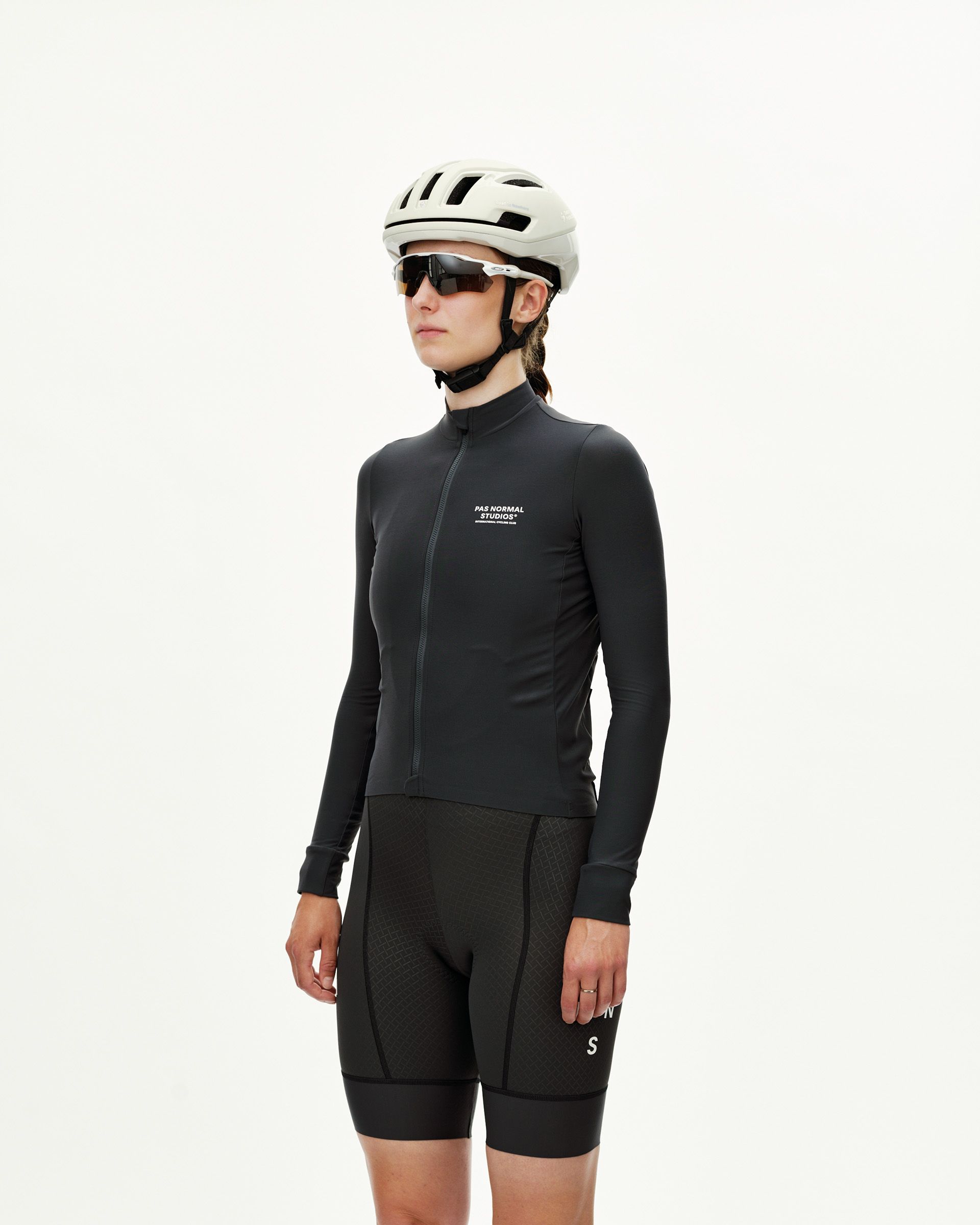 Dark Navy Mechanism women's long sleeve cycling jersey, front view on model with white chest logo print