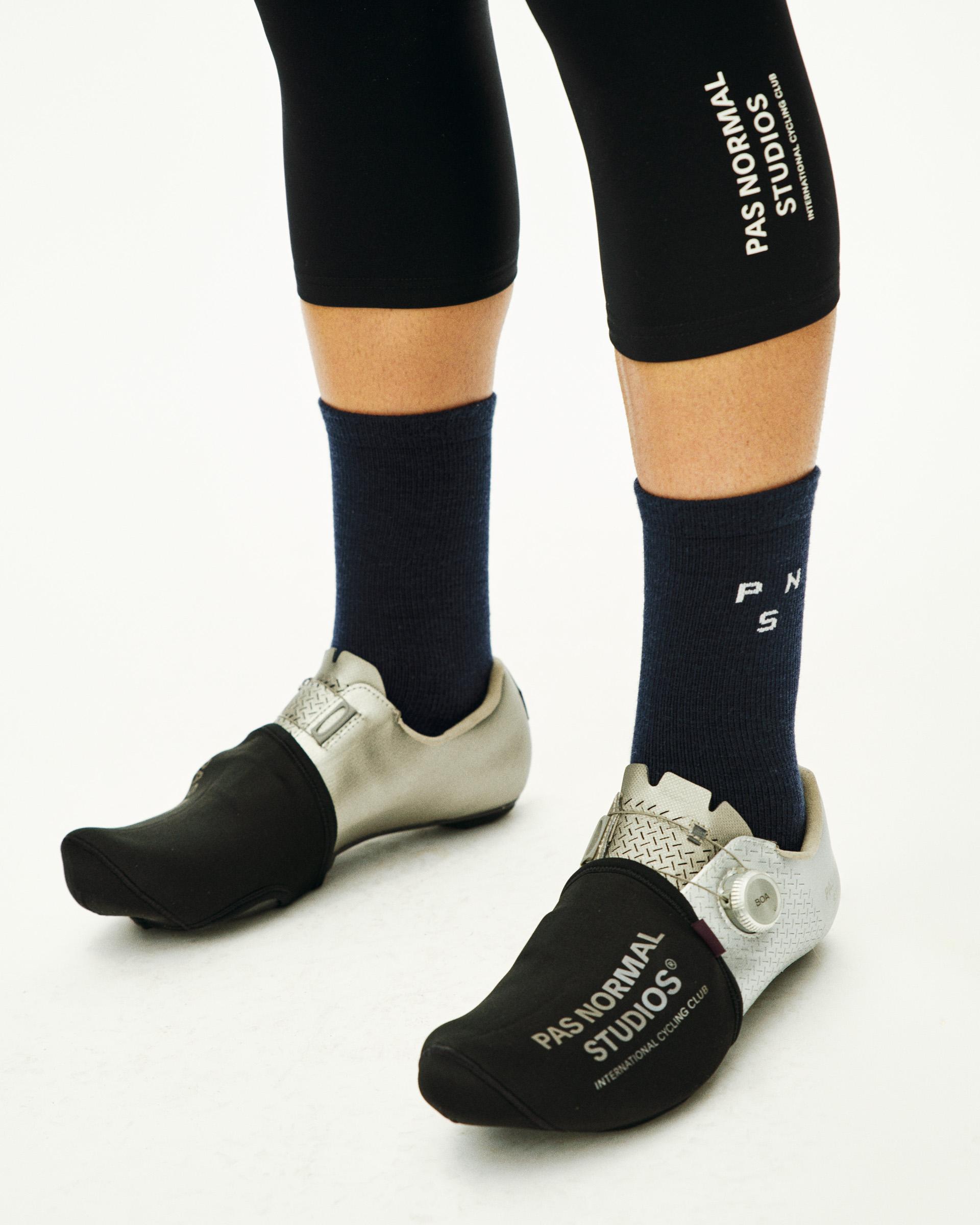 Navy Thermal Wool cycling socks on model with white logo text