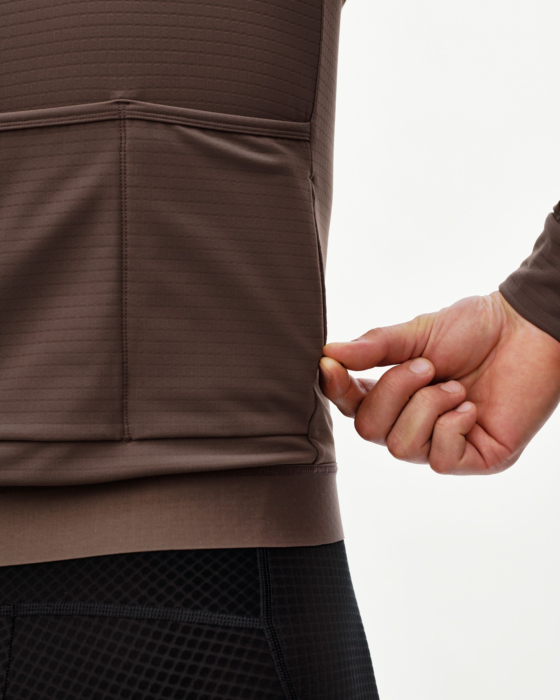 Dusty Plum Essential men's long sleeve cycling jersey, rear detail on model showing ribbed hem panel