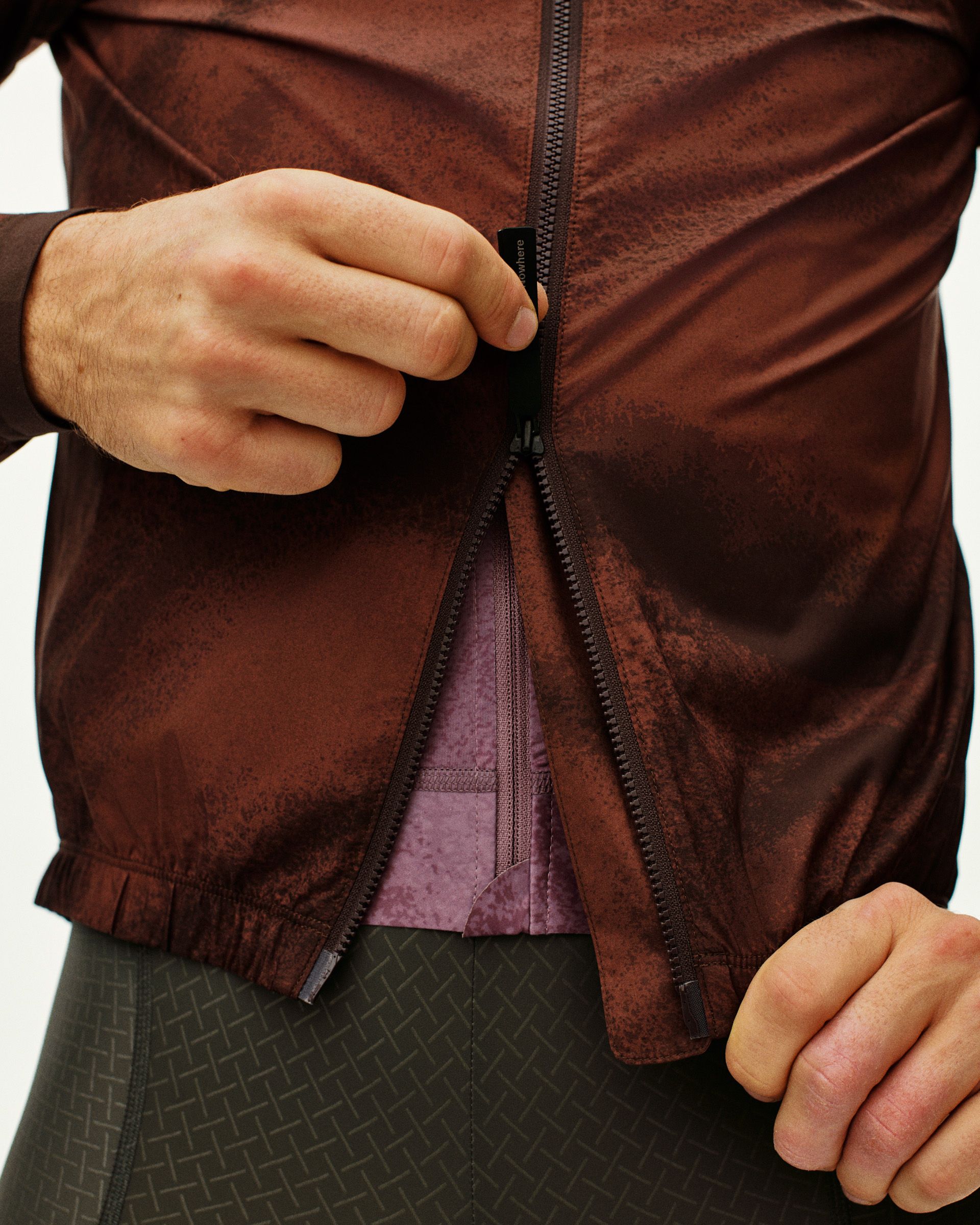 Brown Mechanism Stow Away jacket on model showing open zip with purple inner lining