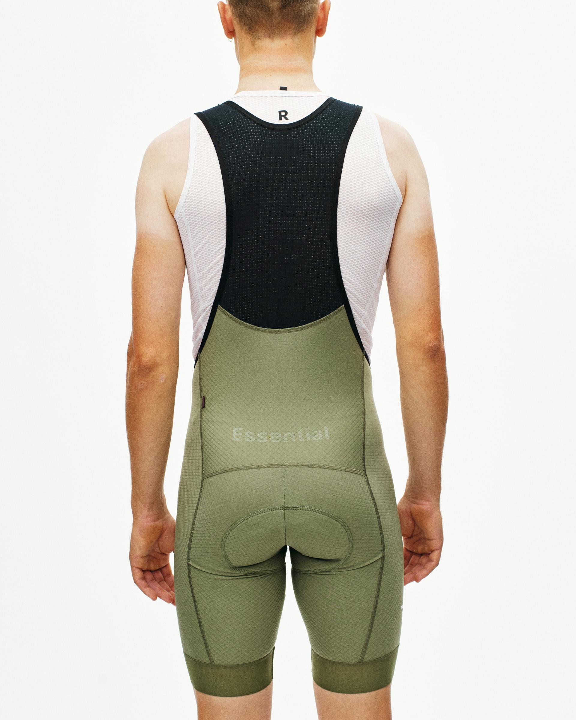 Light Olive Essential cycling bibs on model, rear view with black mesh bib straps