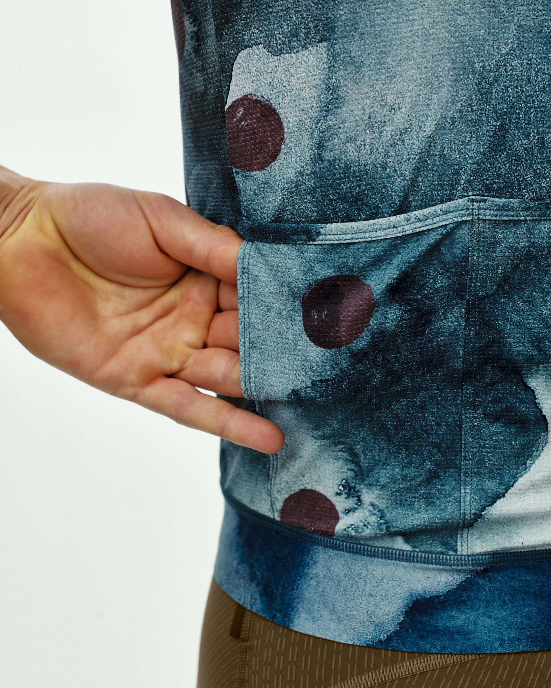 Dark Purple T.K.O. Essential Light cycling jersey on model with burgundy dot print