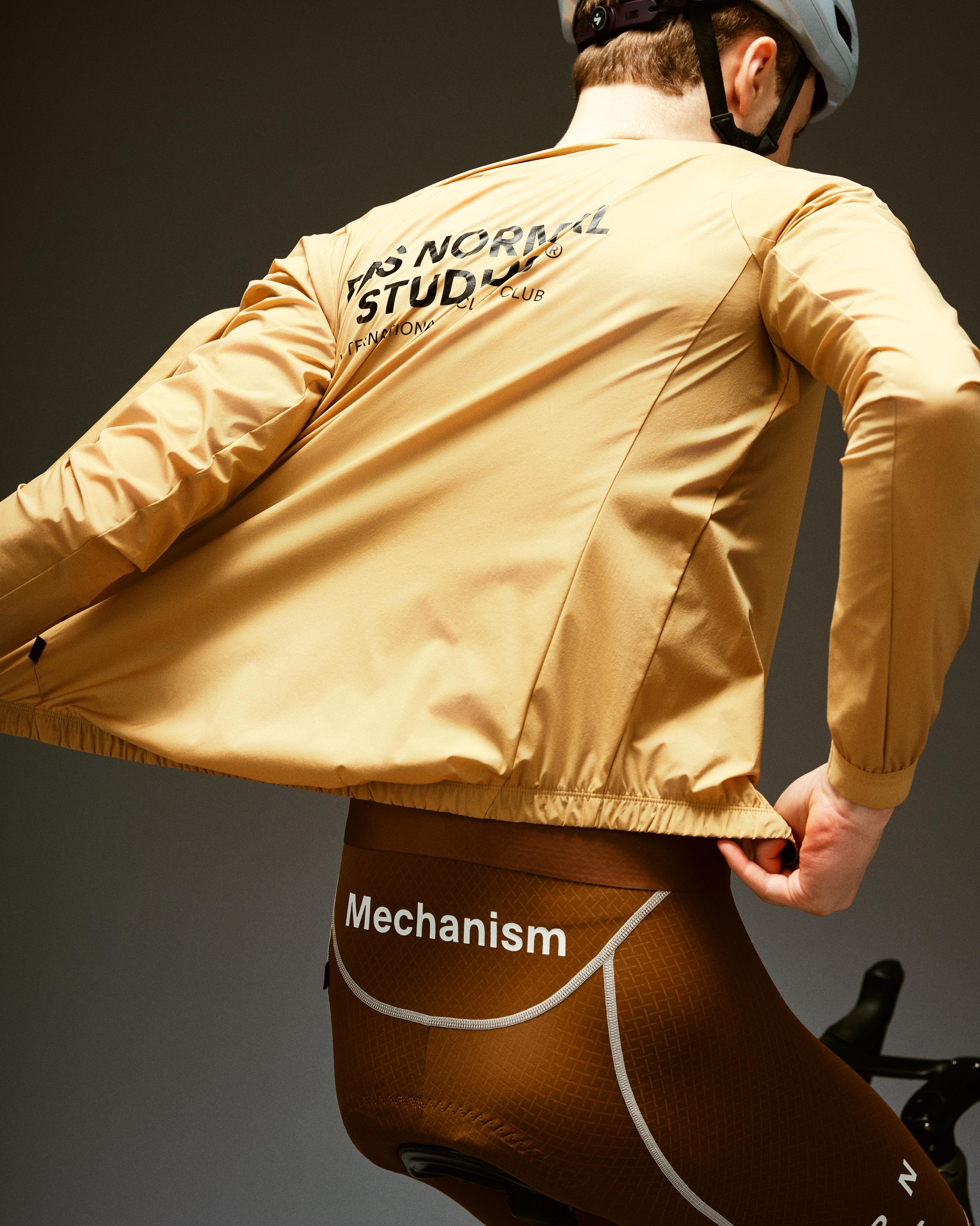 Camel Mechanism Stow Away jacket on model, rear view with black back print