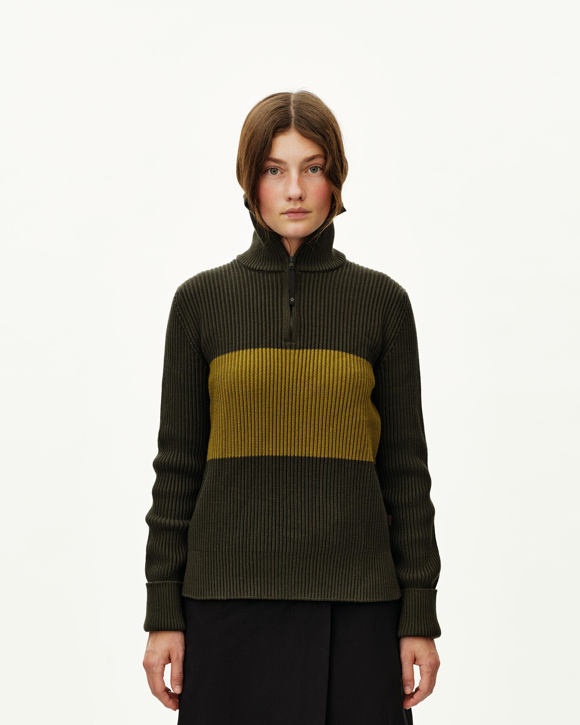 Olive Off-Race Merino Knit Half-Zip sweater on model, front view with yellow contrast panel