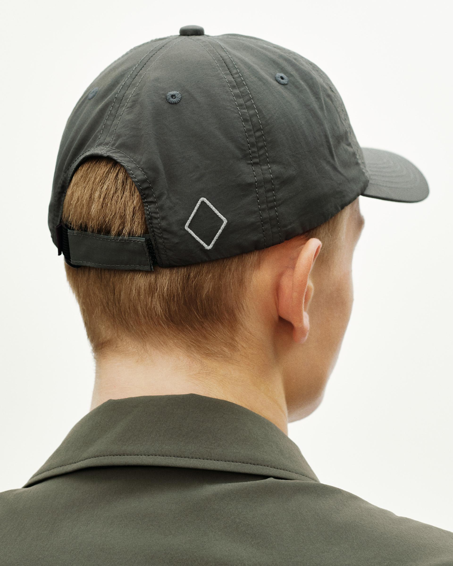 Dark Grey Off-Race cap, rear view on model with white diamond logo and adjustable strap