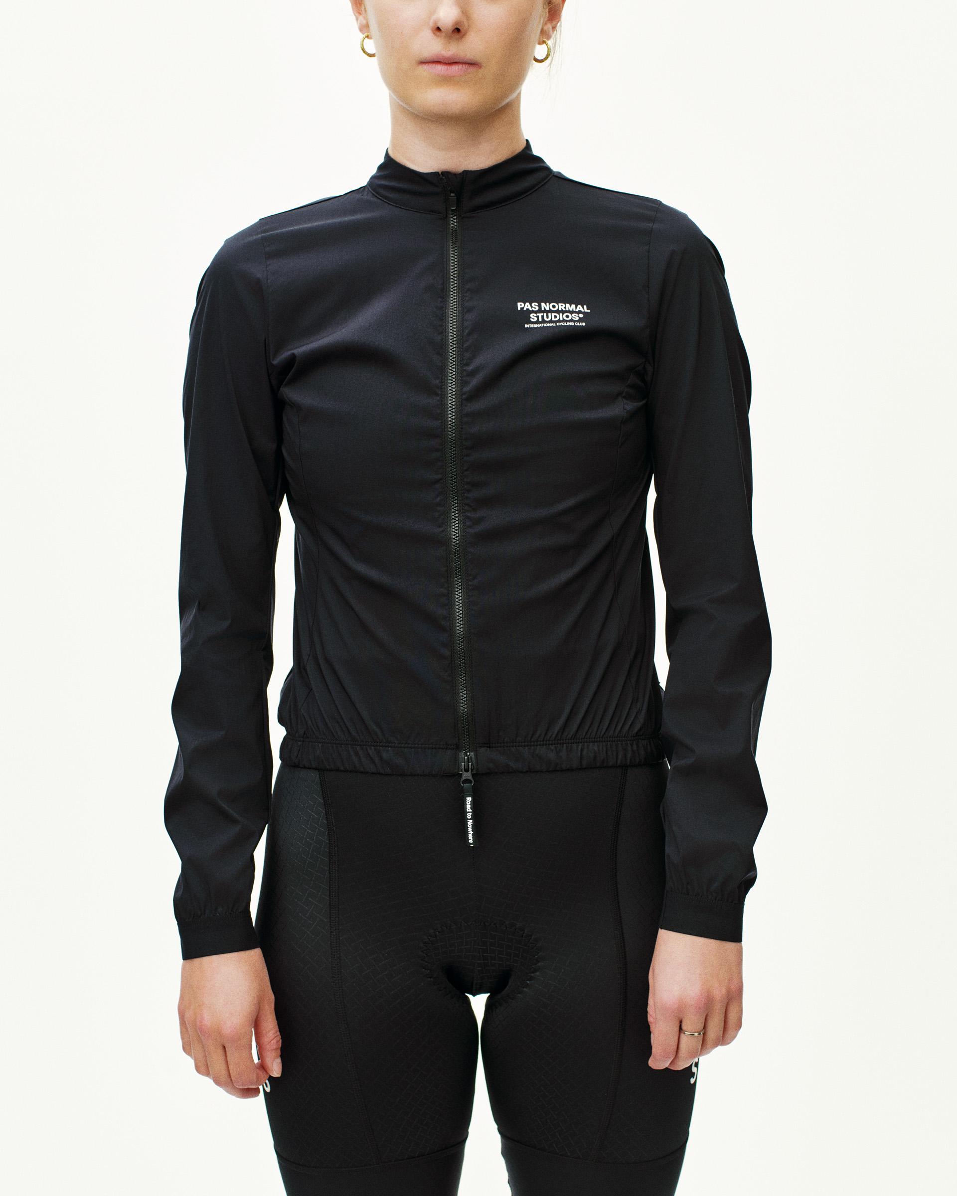 Black Mechanism Stow Away jacket on model with full zip and white chest logo