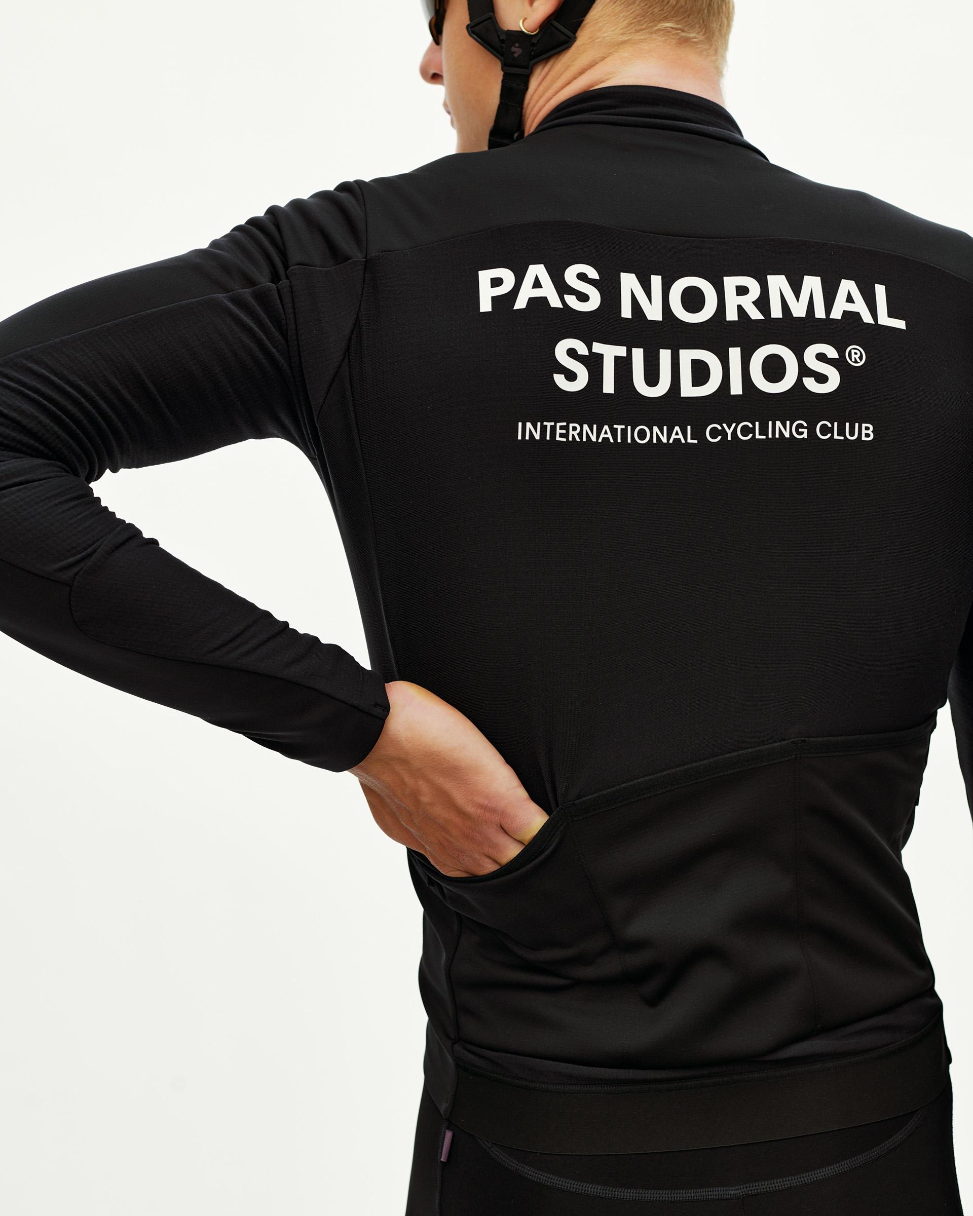 Black Mechanism Thermal Long Sleeve cycling jersey on model, rear view with white International Cycling Club back print