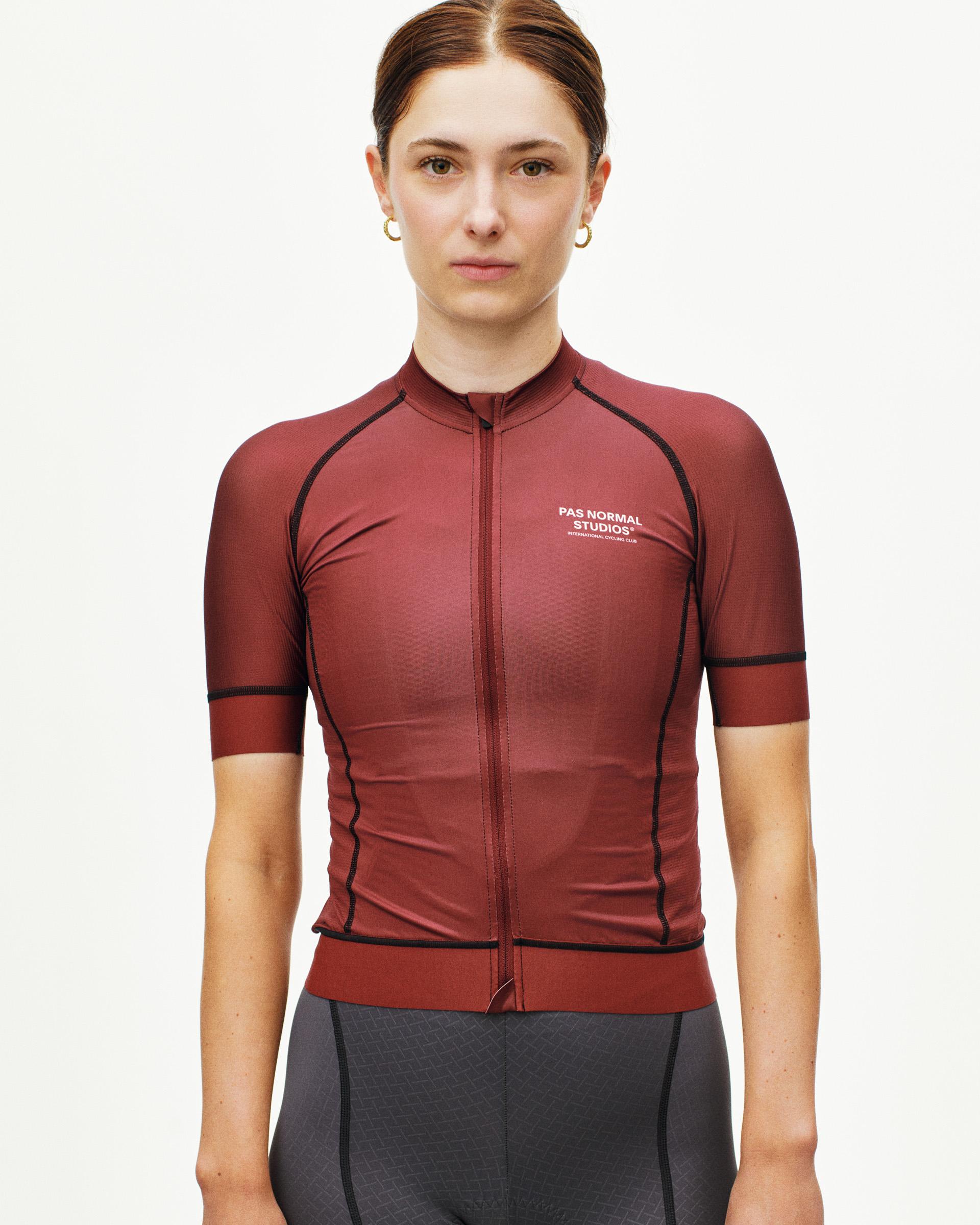 Maroon Mechanism cycling jersey on model with contrast black piping and textured fabric panels