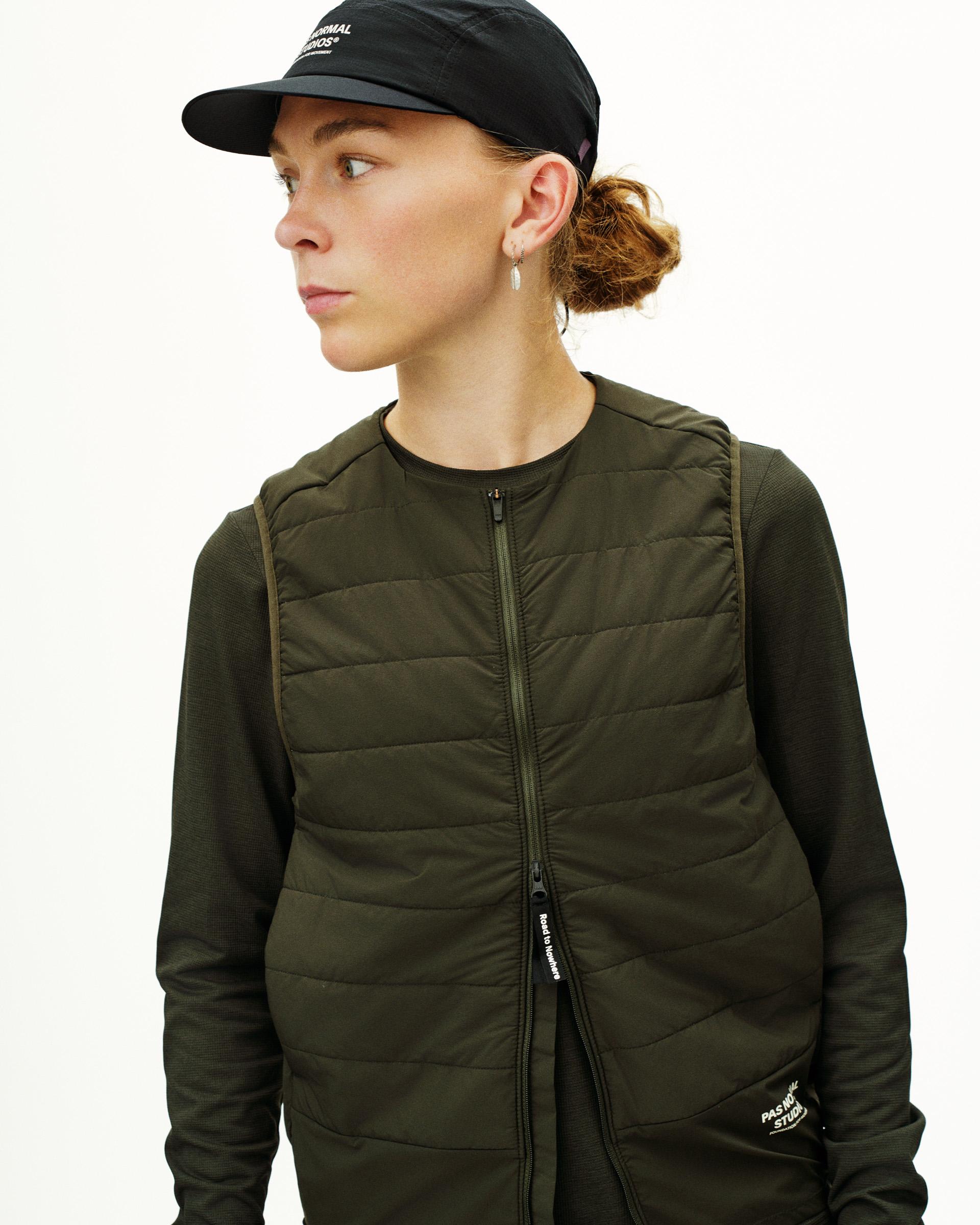 Dark Olive Balance insulated vest on model, side view with quilted front panel and zip closure
