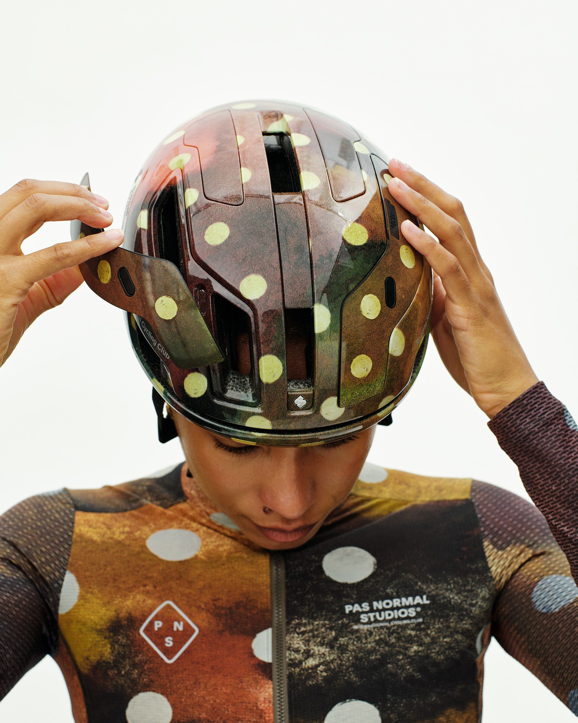 Brown T.K.O. Falconer Aero 2Vi cycling helmet on model with yellow polka dot pattern