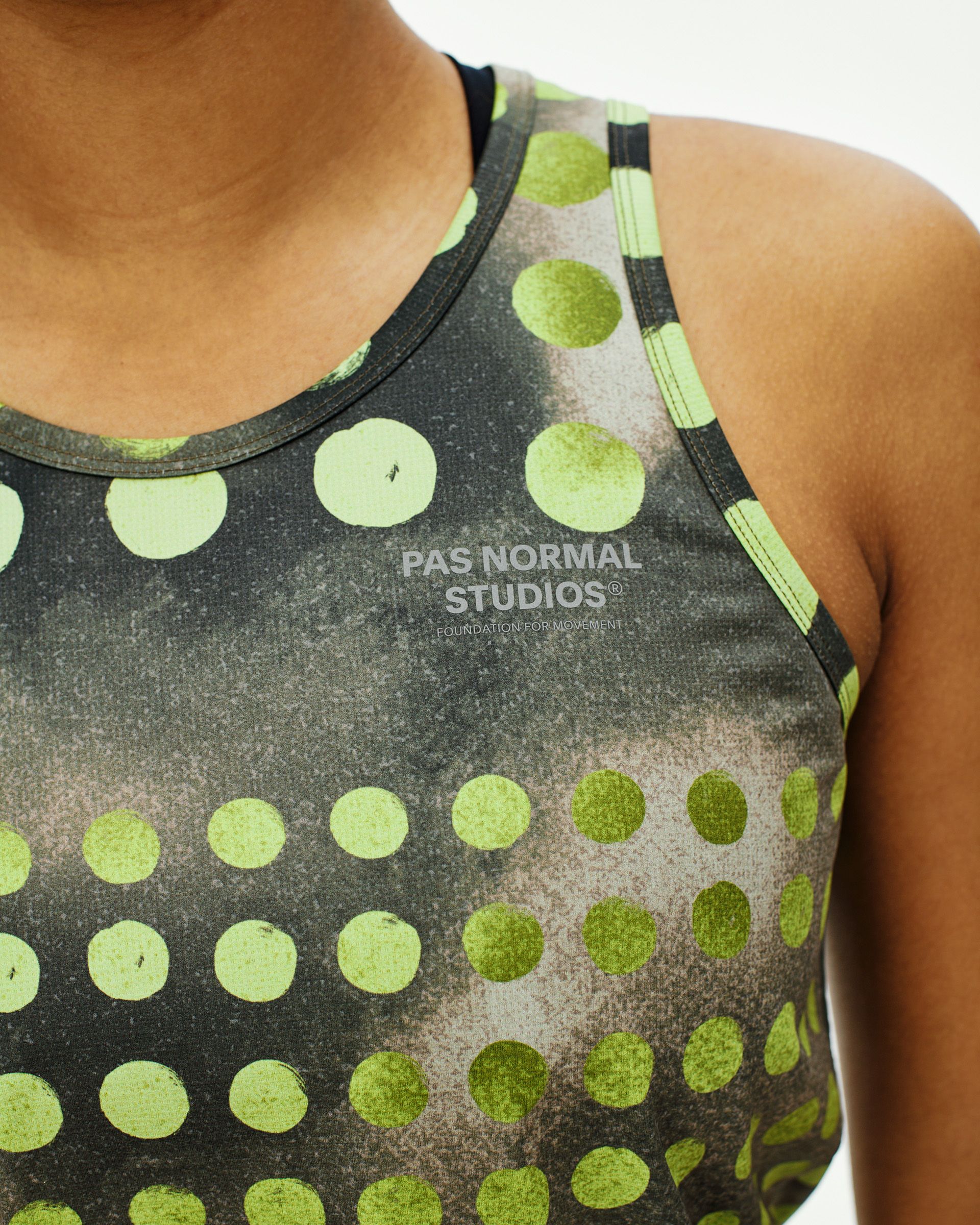 Green T.K.O. Balance singlet on model with lime green polka dot print