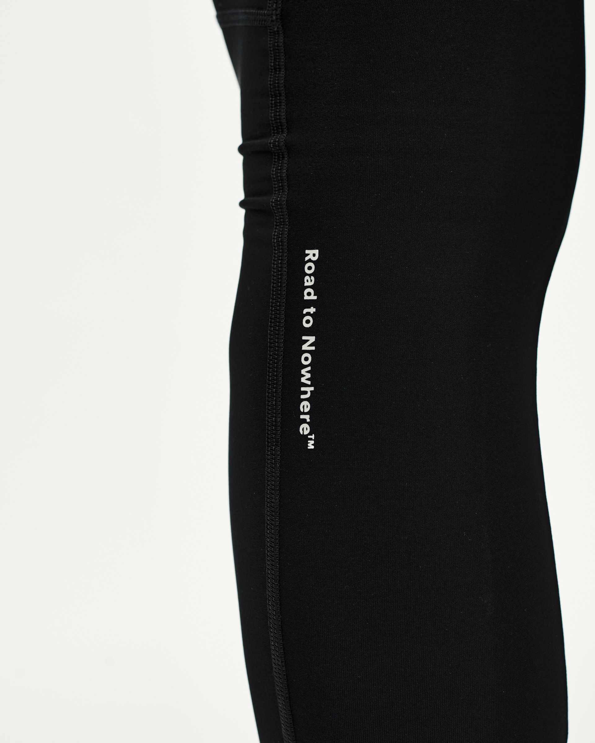 Black Mechanism Thermal Long cycling bibs, side detail view with white Road to Nowhere leg print