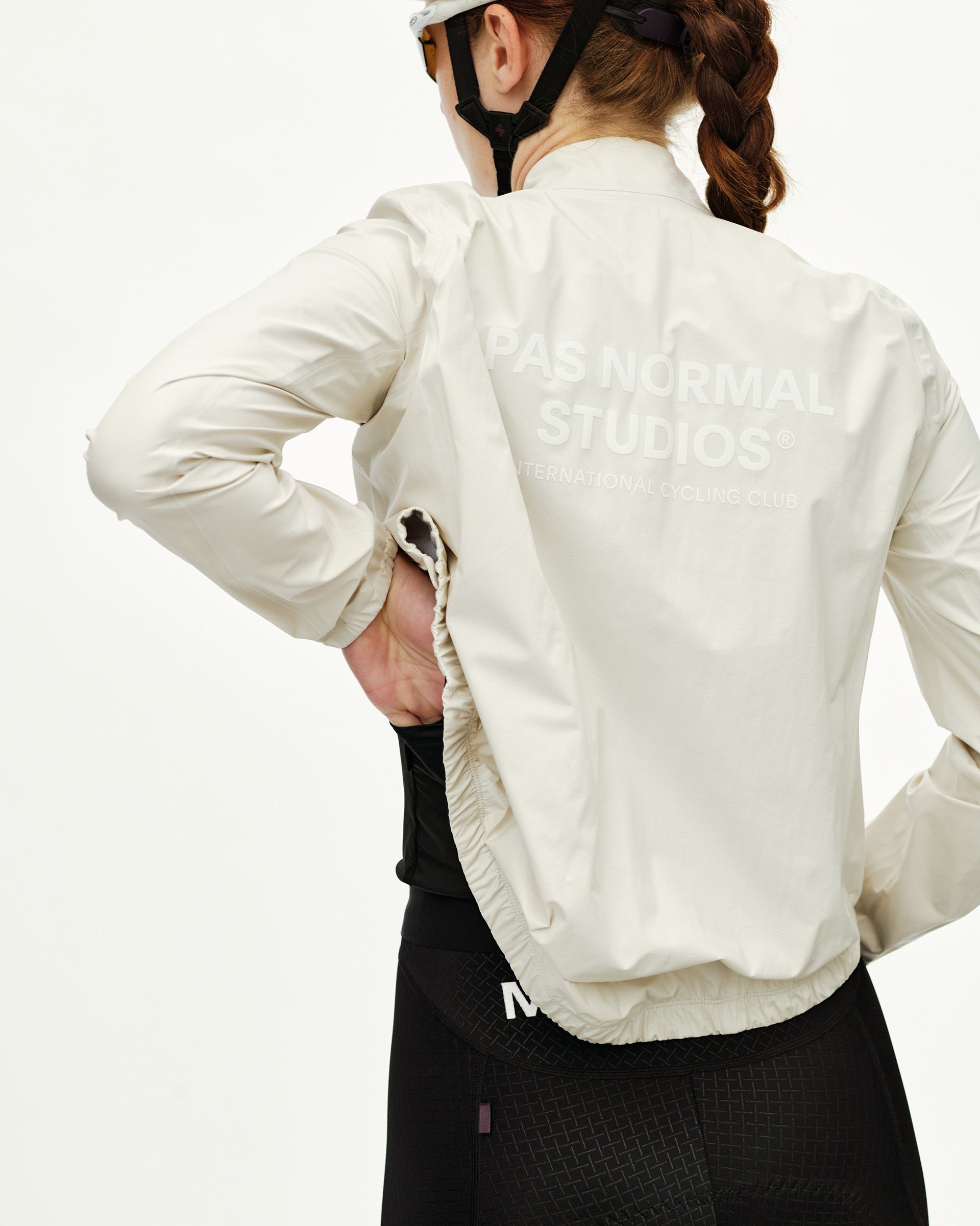 Off White Mechanism women's cycling rain jacket, rear view on model with tonal back print