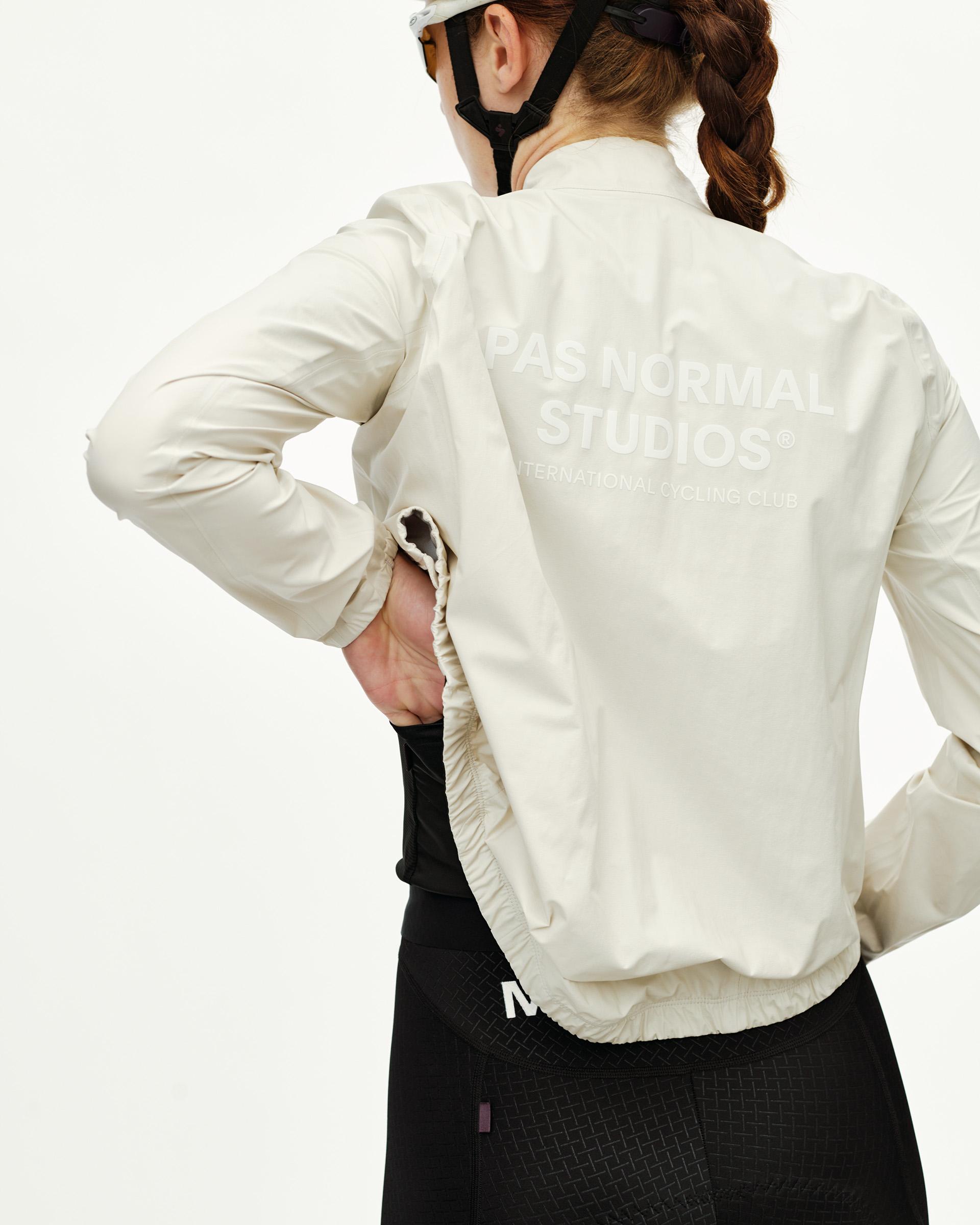 Off White Mechanism women's cycling rain jacket, rear view on model with tonal back print