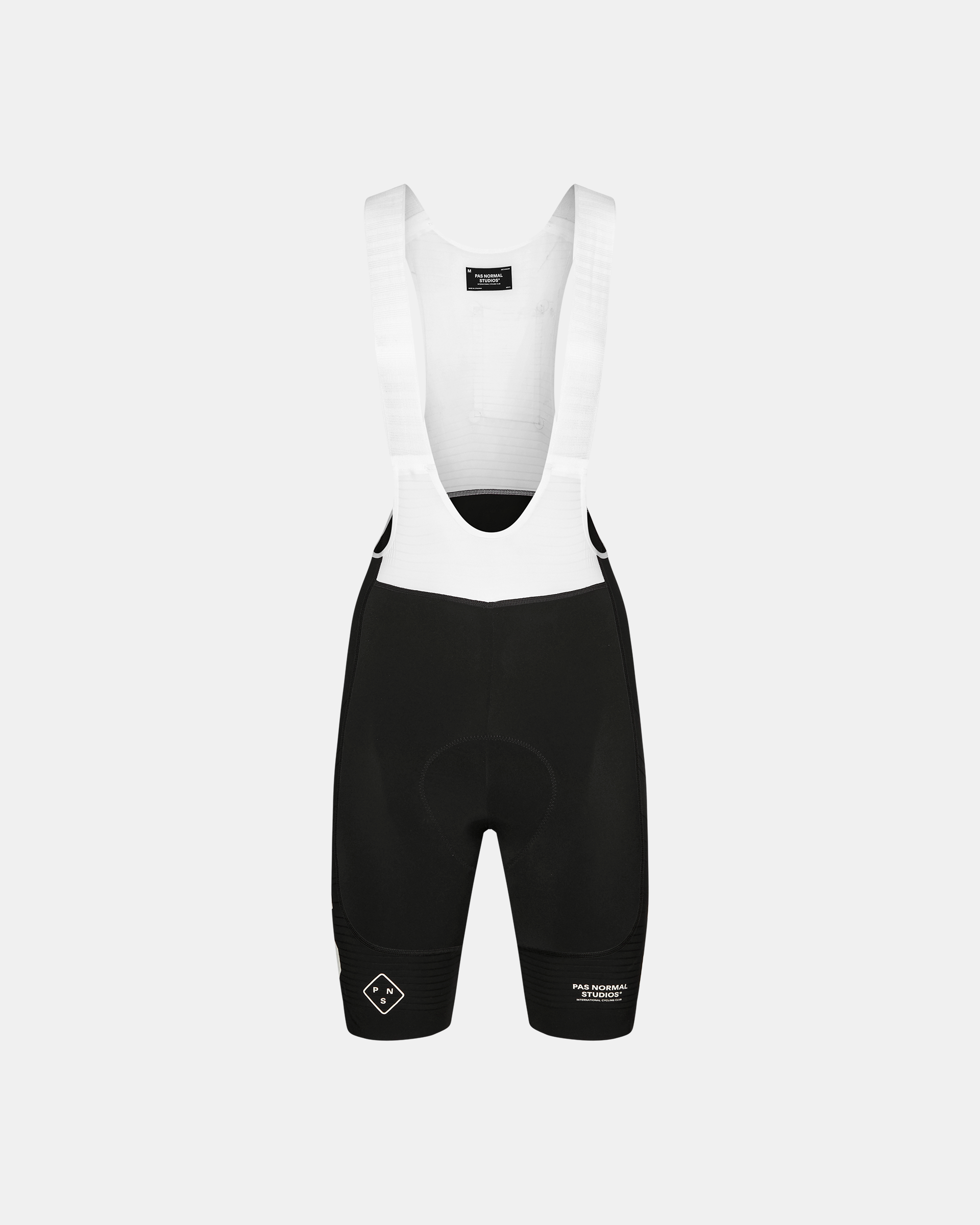 Black PAS Mechanism Pro bibs, front flat lay with white bib straps and black shorts