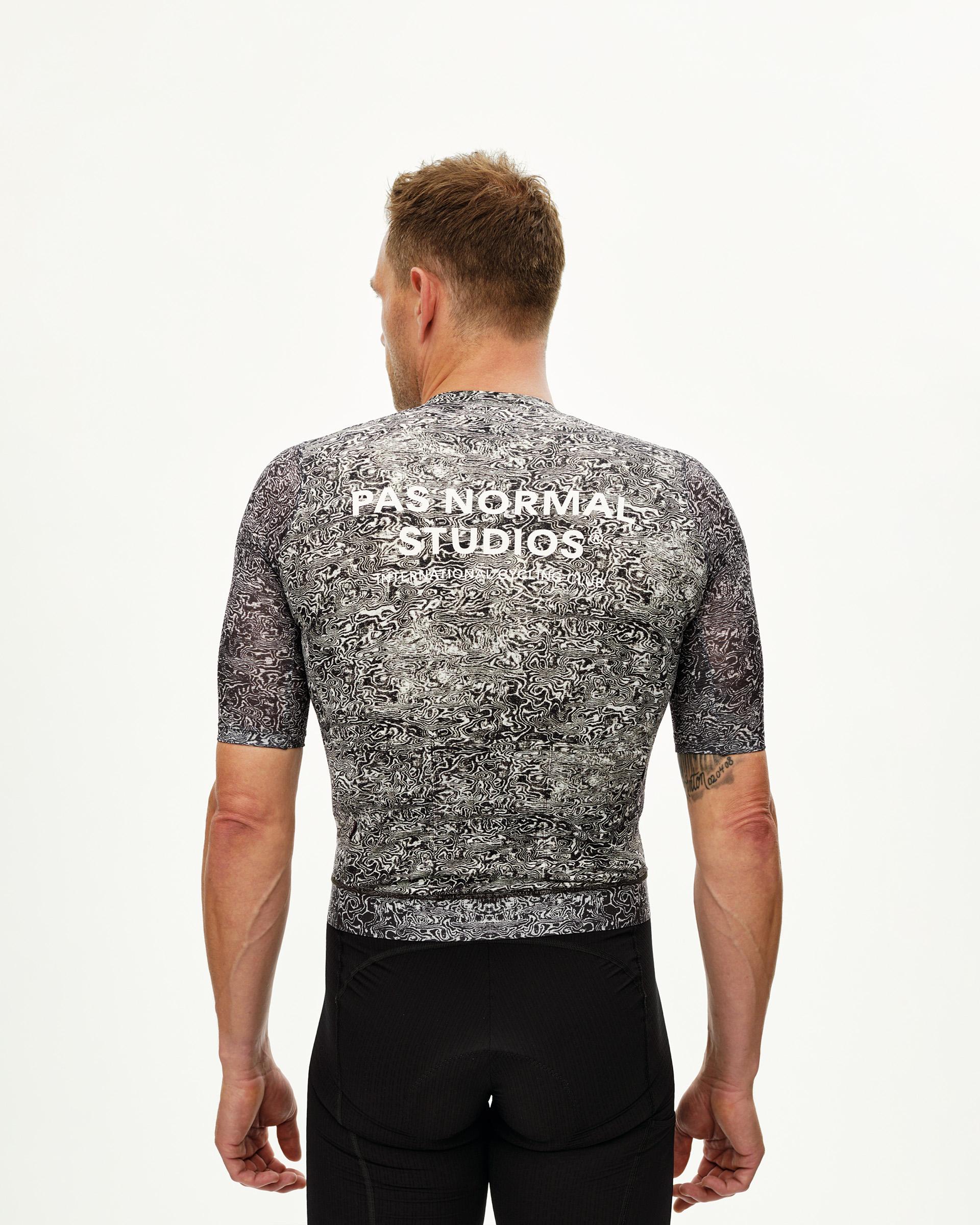 Off White Essential cycling jersey on model, rear view with black and white swirl AOP print