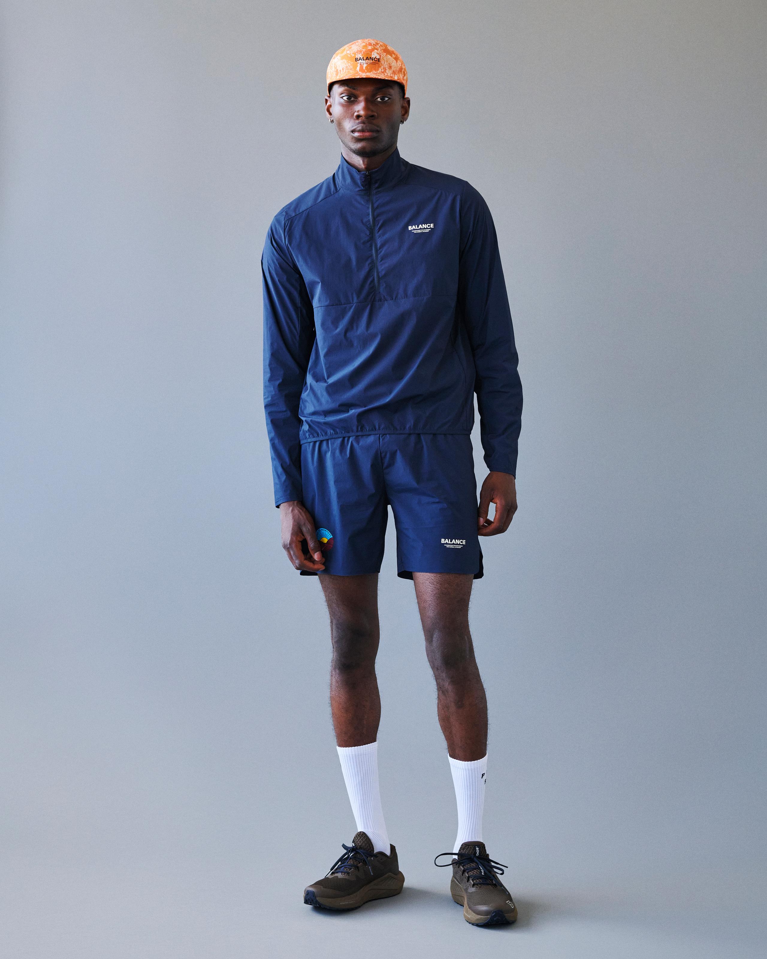 Navy Balance Half Zip jacket on model, front view with chest logo print