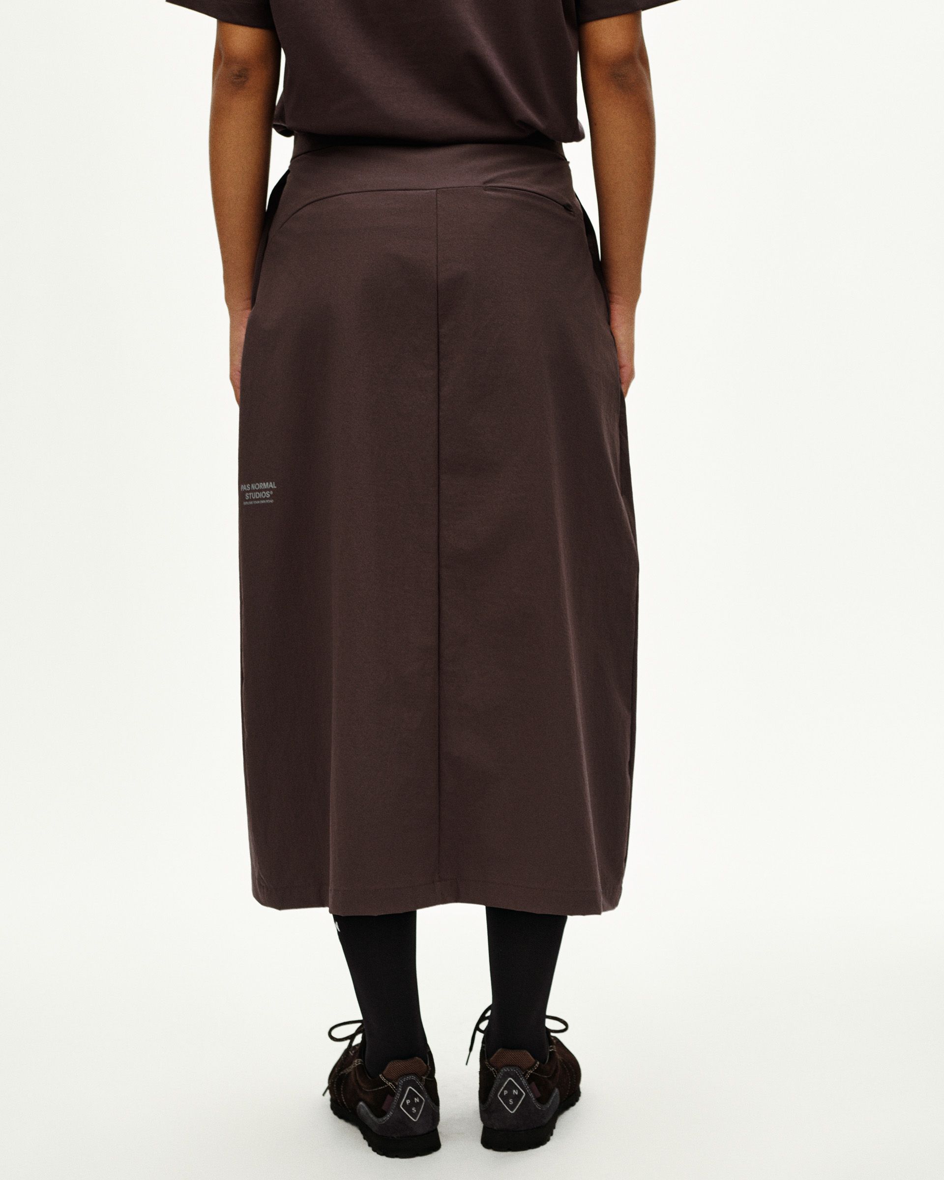 Dark Purple Off-Race Tech skirt on model, rear view with center seam and white logo detail