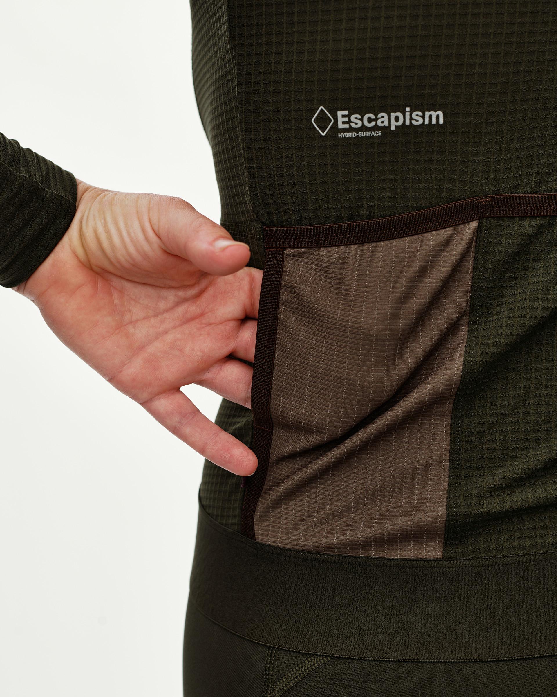 Dark Olive Escapism long sleeve cycling jersey, rear detail on model showing contrast pocket with dark trim