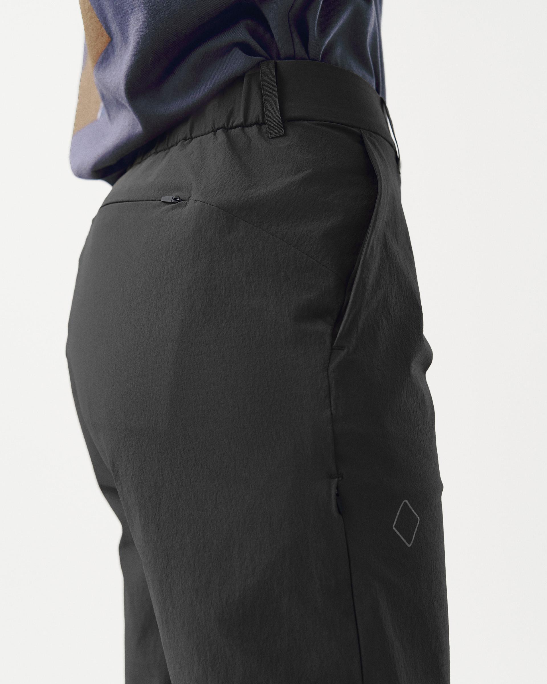 Black Off-Race Tech pants, side view on model with zippered back pocket and diamond logo
