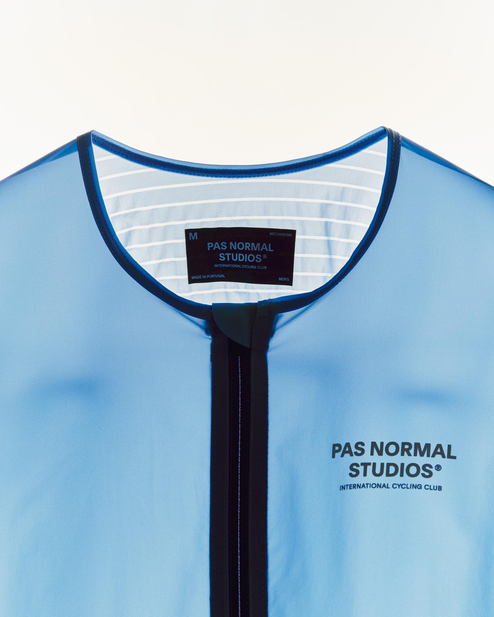 Men's Mechanism Pro Jersey in light blue with navy trim and chest branding, close-up of neckline and zipper