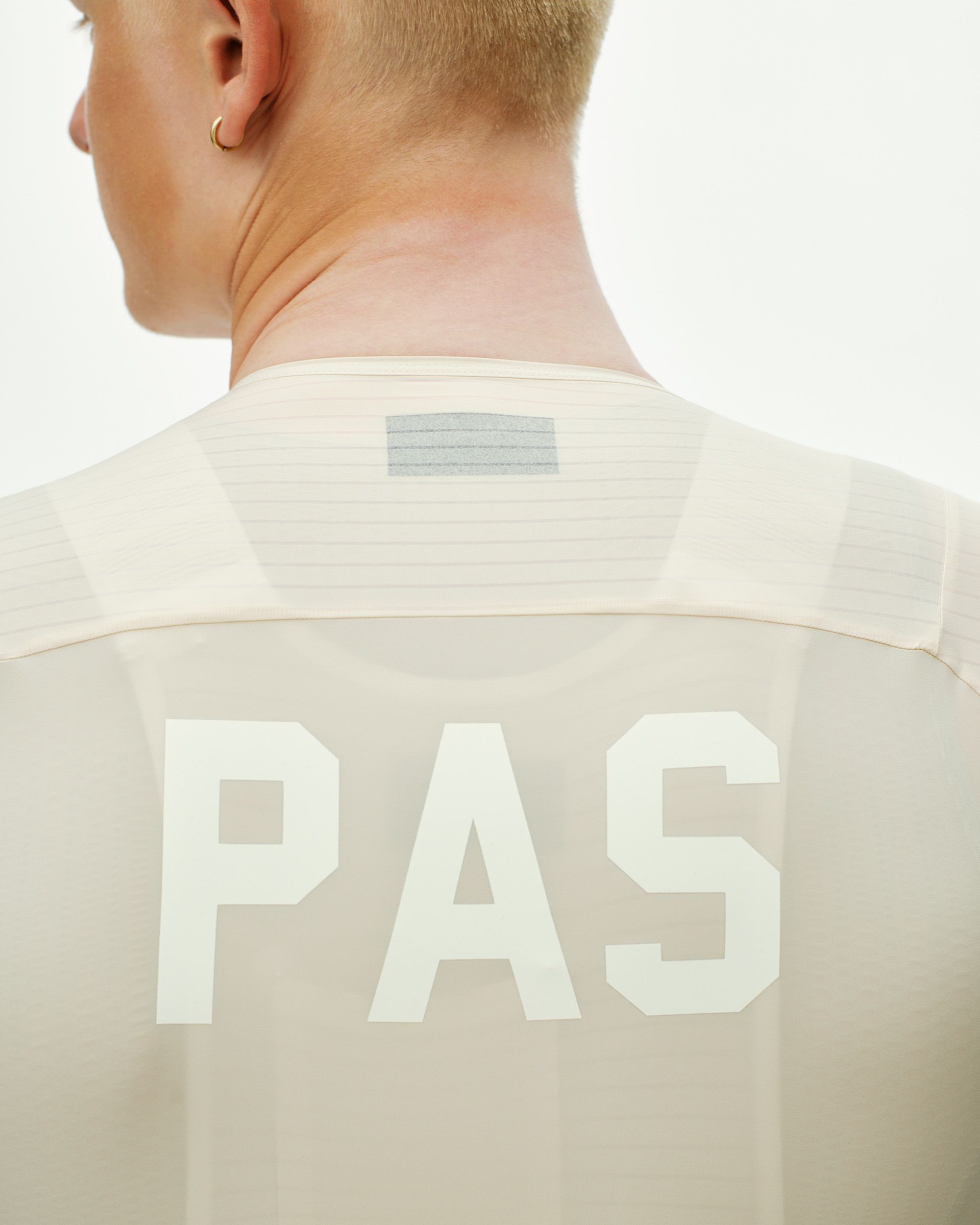 Cream PAS Mechanism Pro cycling jersey, rear view on model with white logo