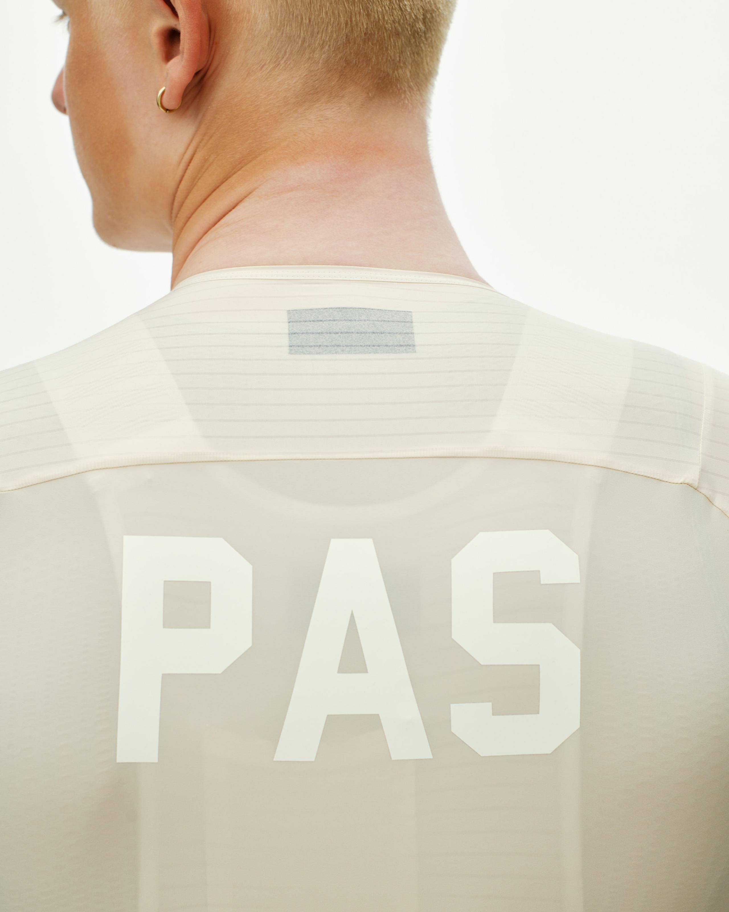 Cream PAS Mechanism Pro cycling jersey, rear view on model with white logo