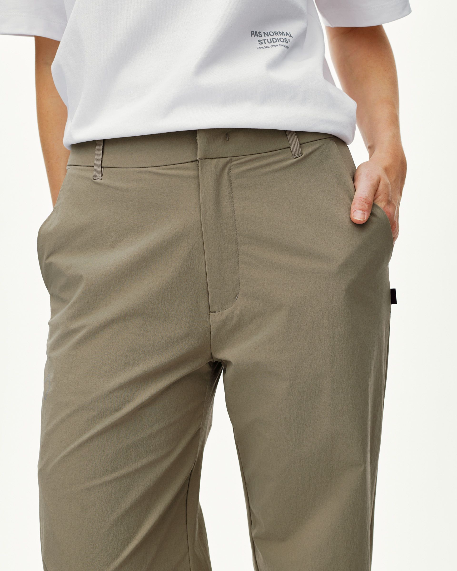 Dusty Earth khaki Off-Race Tech pants on model, front view with belt loops and side pockets