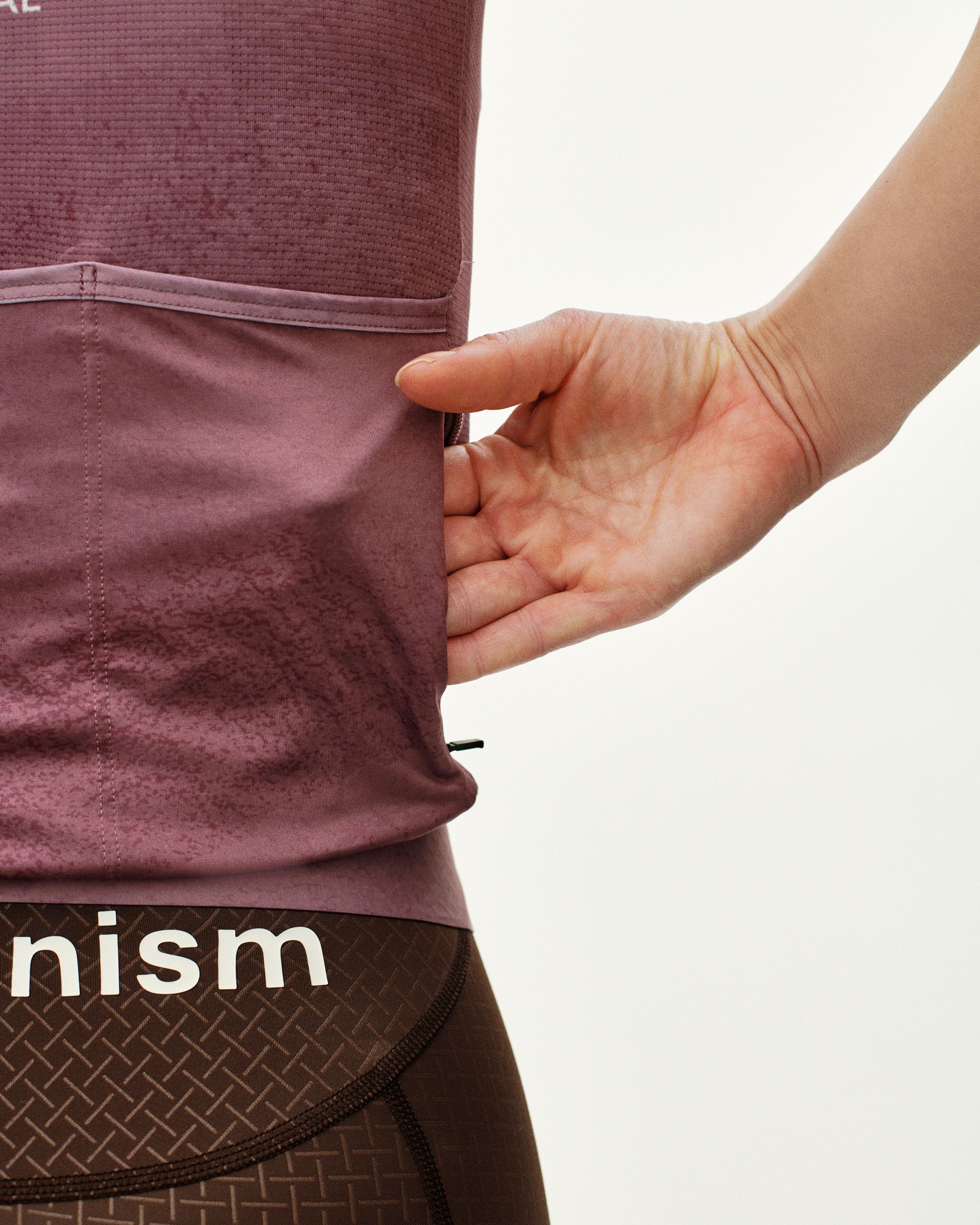Purple Mechanism cycling jersey on model with rear zip pocket detail