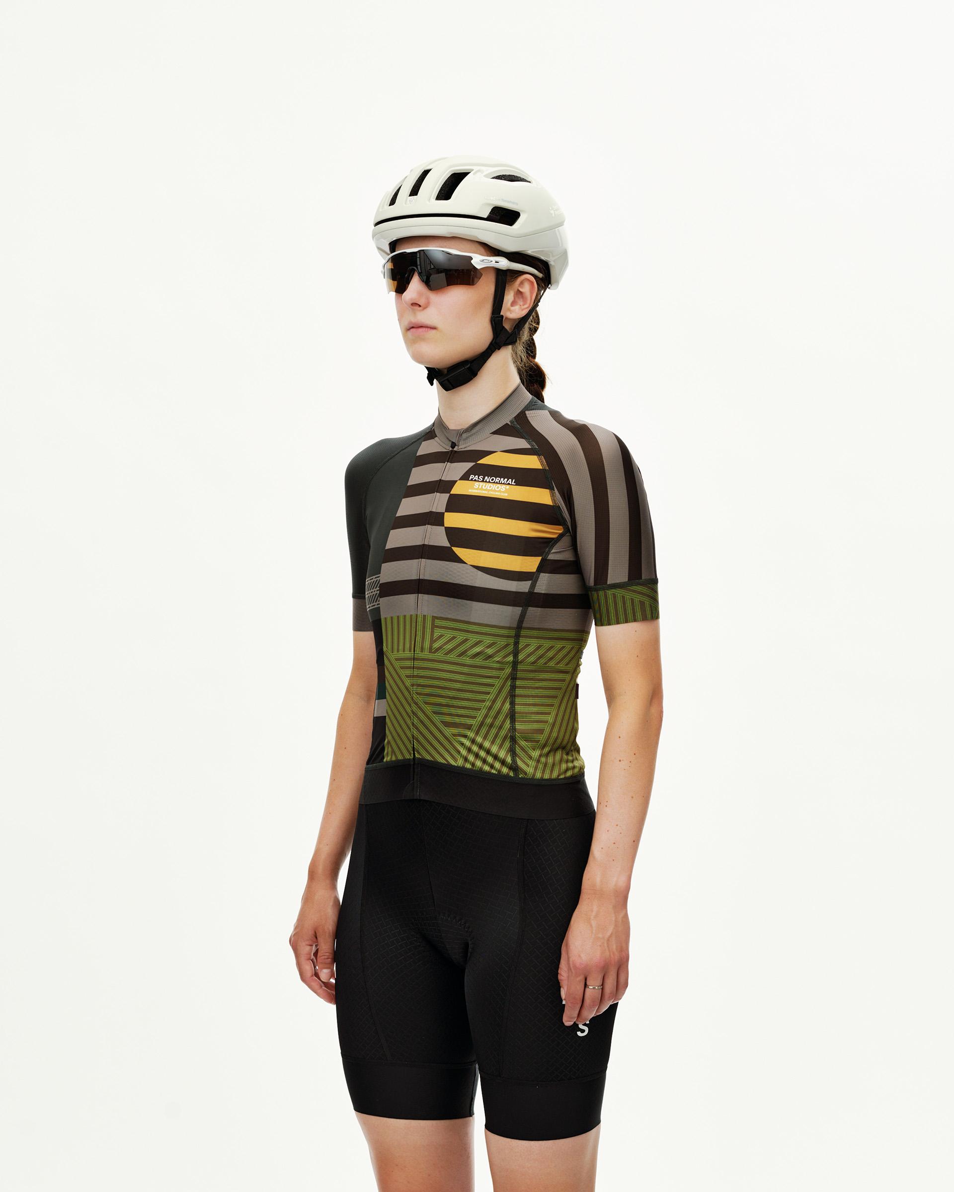 International Earth Mechanism women's cycling jersey on model, three-quarter front view with geometric stripe and circle
