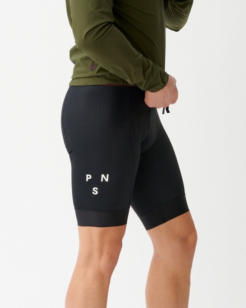Black Mechanism bibs on model, side view with white logo on thigh panel
