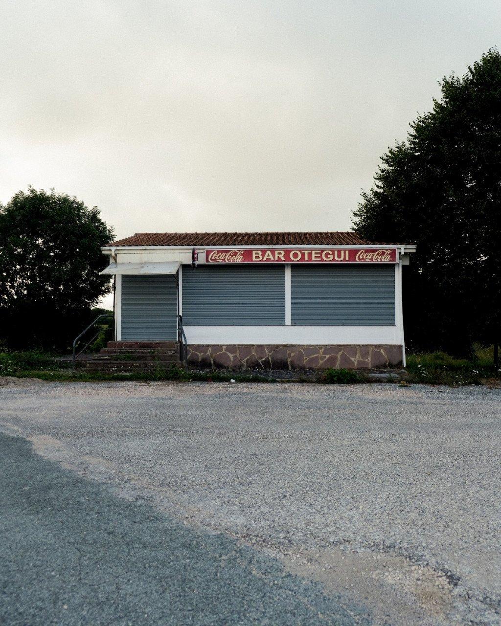 Closed roadside bar with shuttered windows and Coca-Cola signage