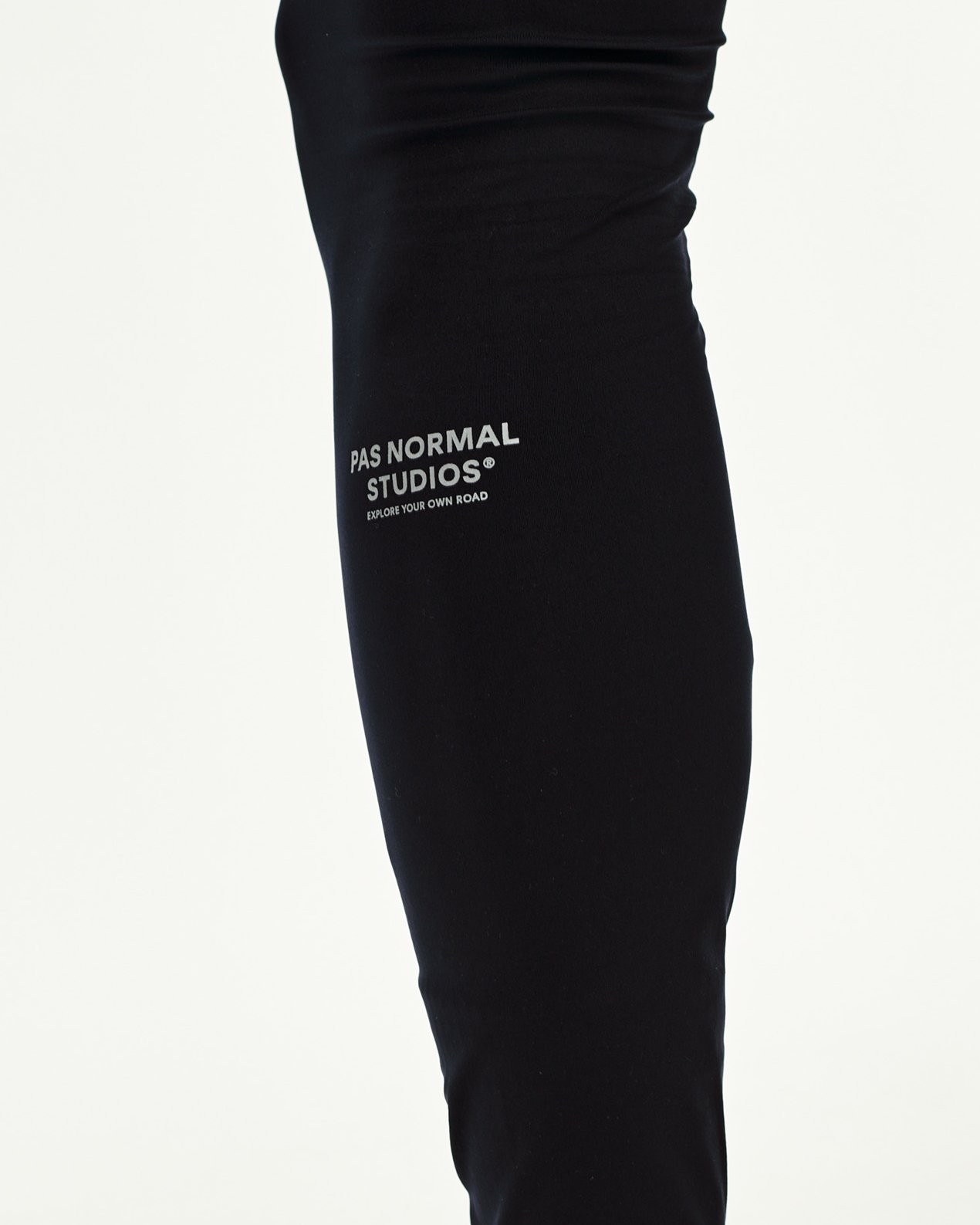 Black Balance long cycling tights, side detail on model with grey logo print