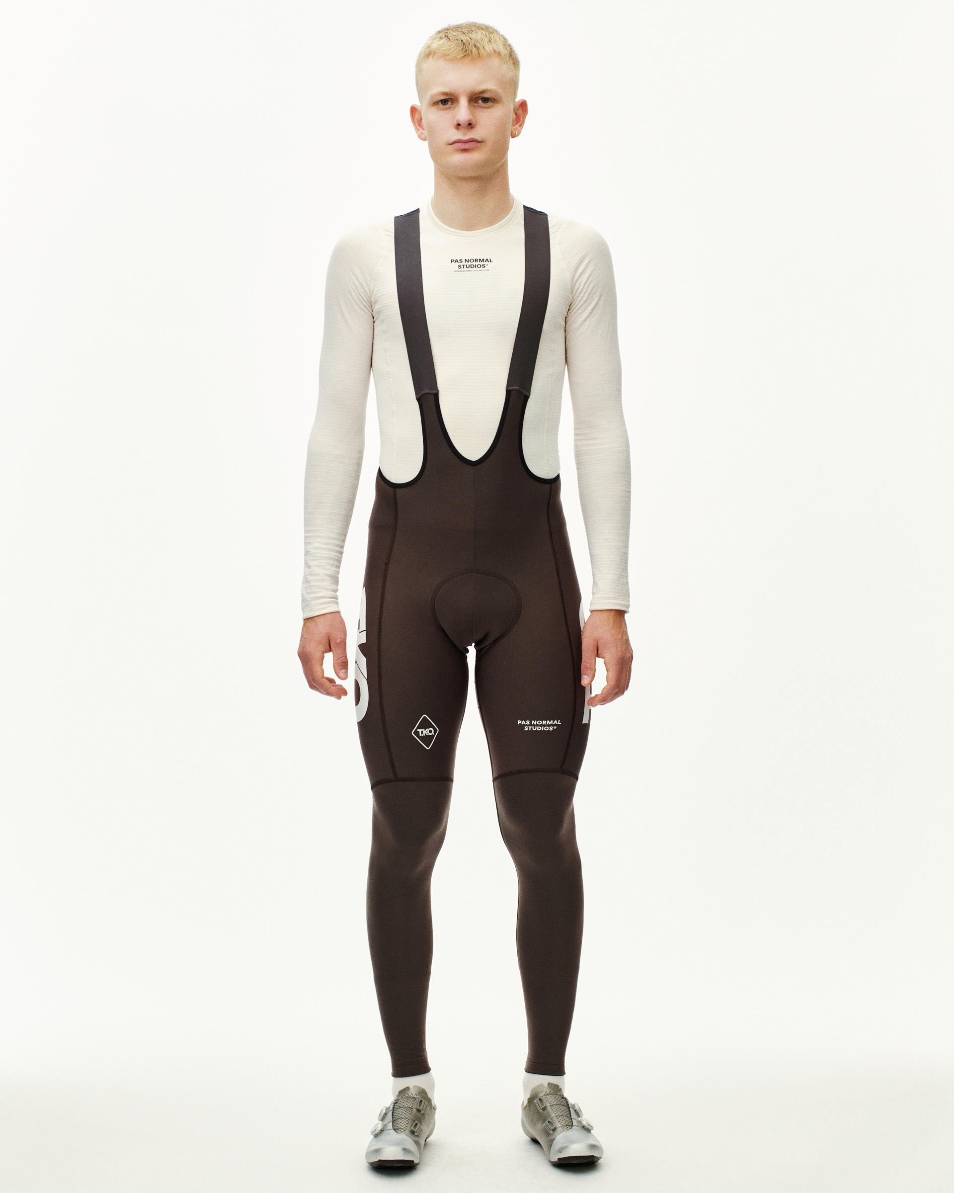 Dark Purple T.K.O. Essential Thermal Long cycling bibs on model, front view with white logo print