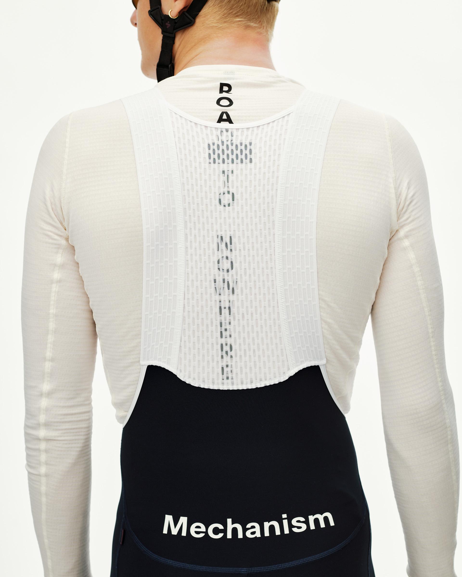 Navy Mechanism cycling bibs on model, rear view with white logo waistband and bib straps