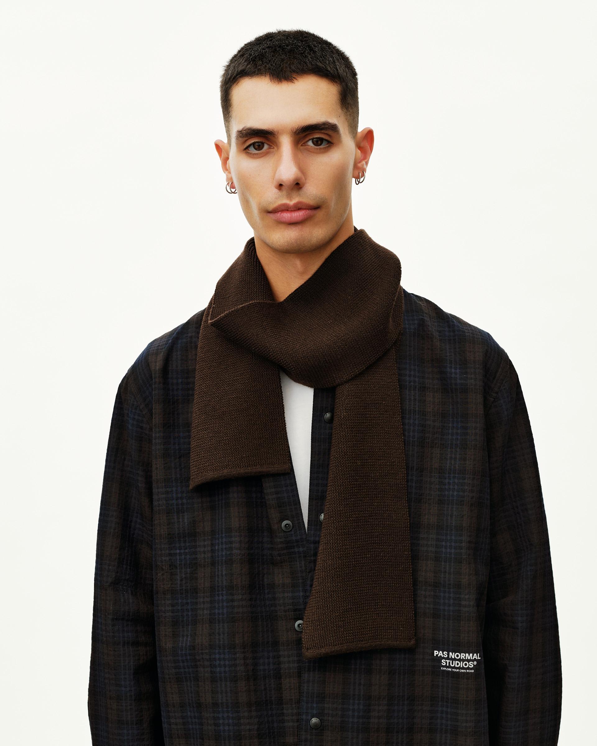 Light Brown Off-Race Wool Knit scarf on model, front view with logo tab at hem