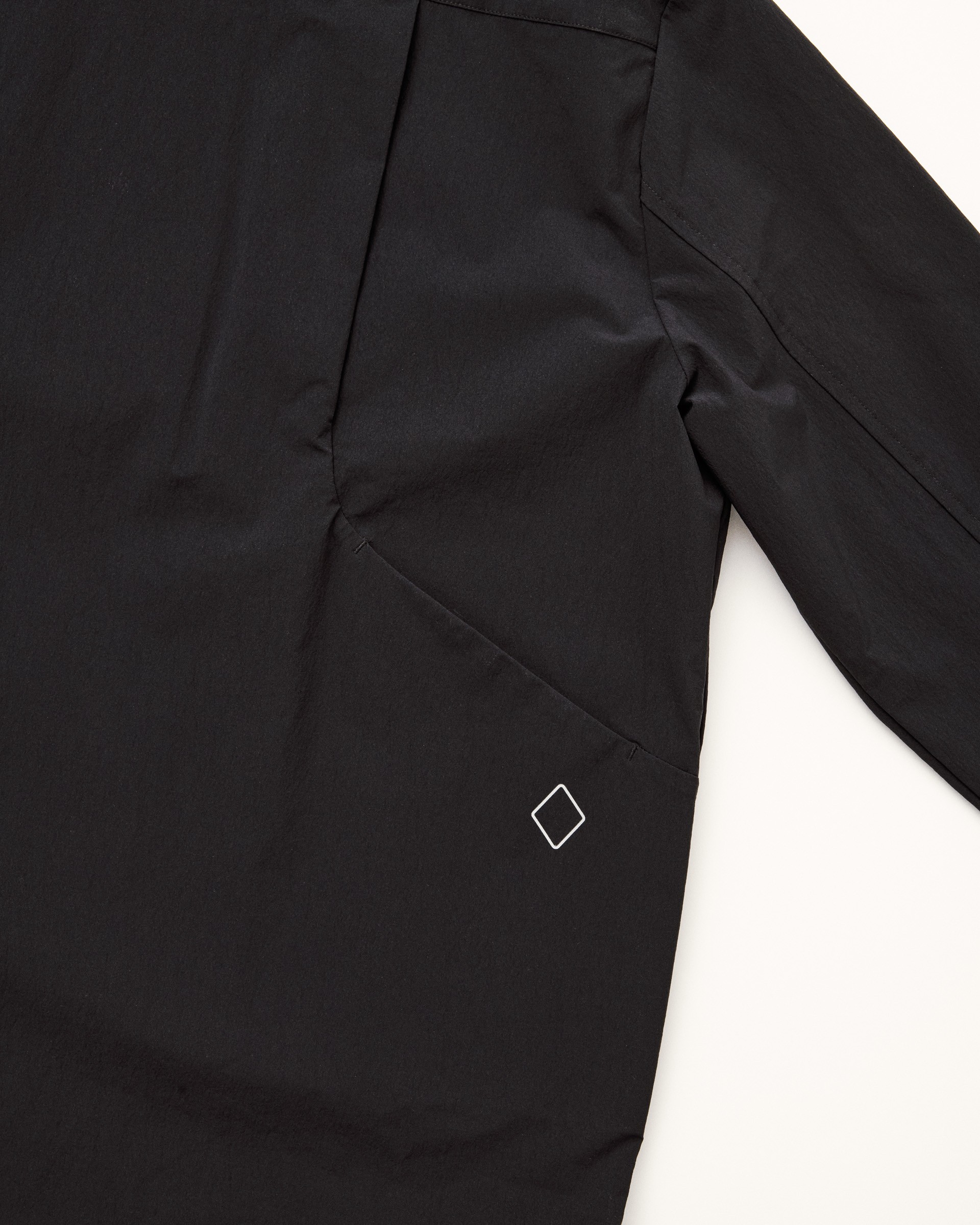 Black nylon stretch fabric with water-resistant coating and diamond logo branding