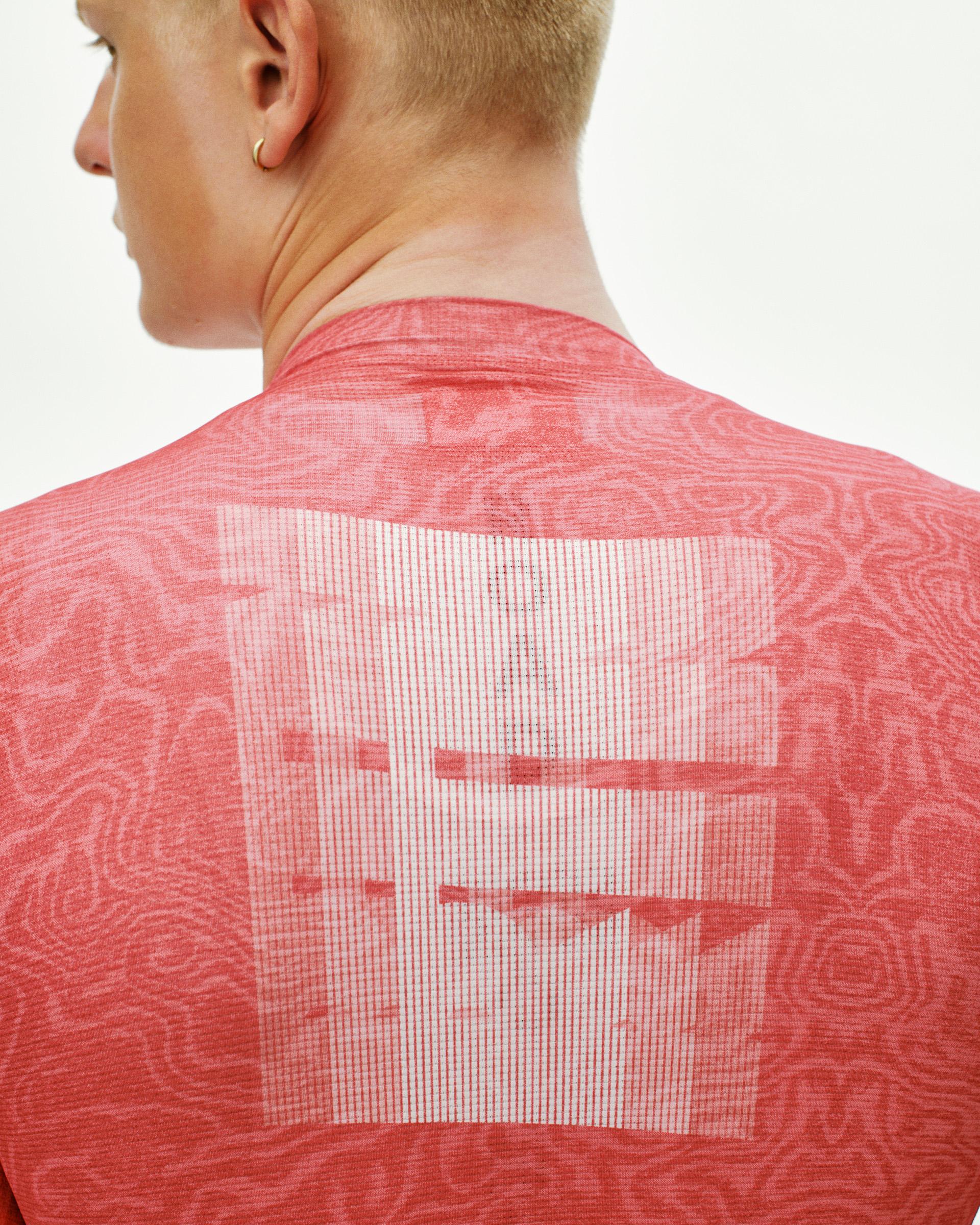 Red Mechanism cycling jersey, rear detail on model showing tonal topographic print and large back logo graphic