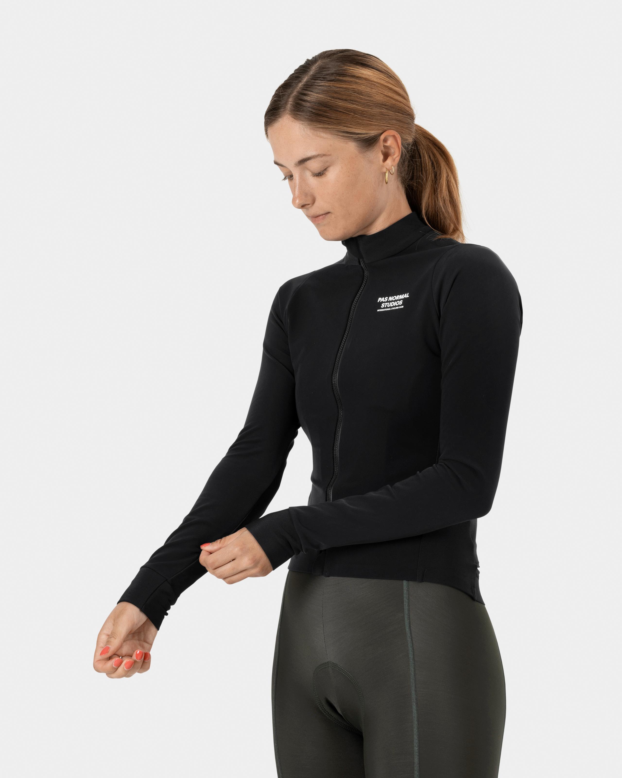Black Mechanism Thermal long sleeve cycling jersey on model with half zip and white chest logo