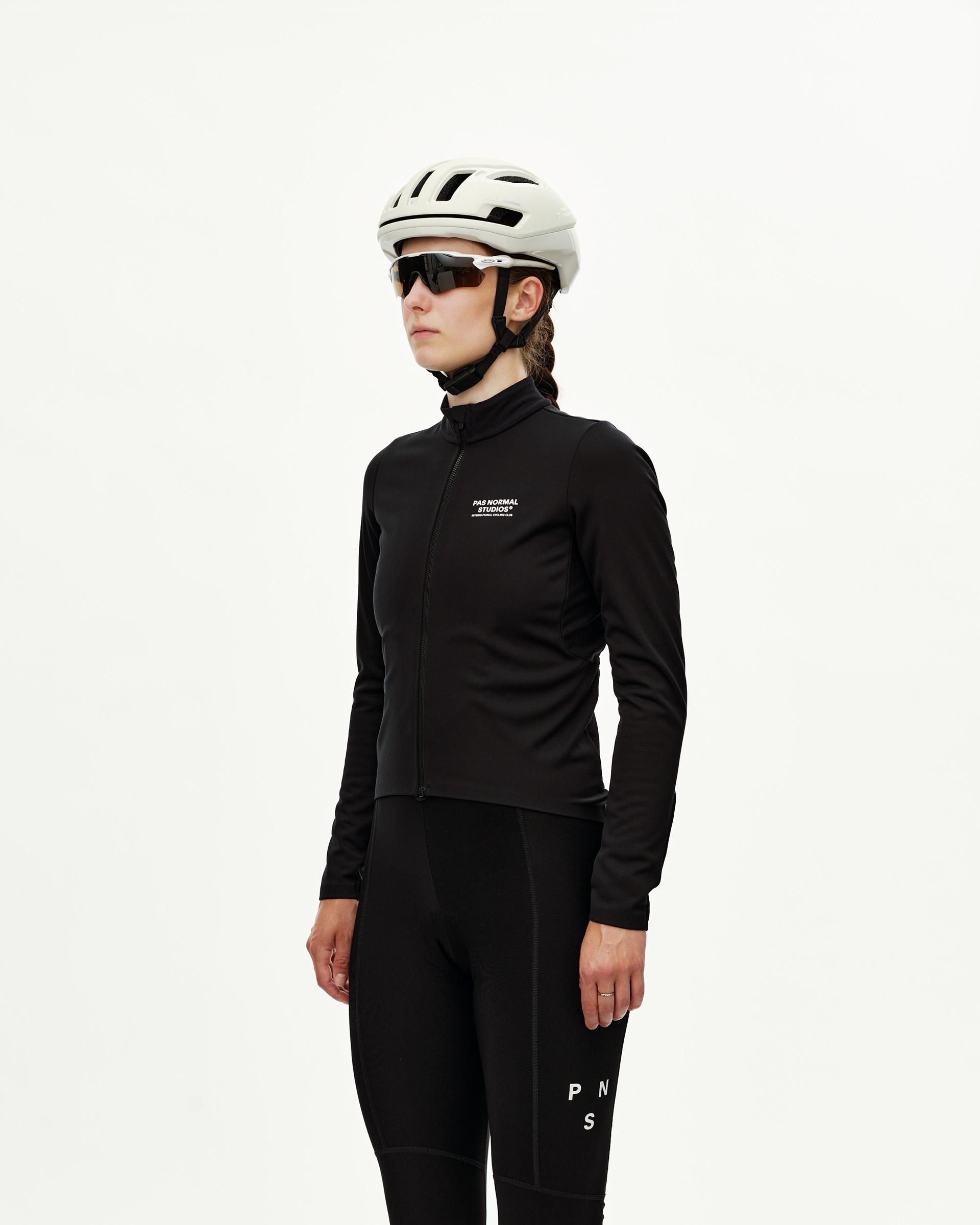 Black Mechanism Thermal Long Sleeve cycling jersey on model, three-quarter front view with white chest logo print