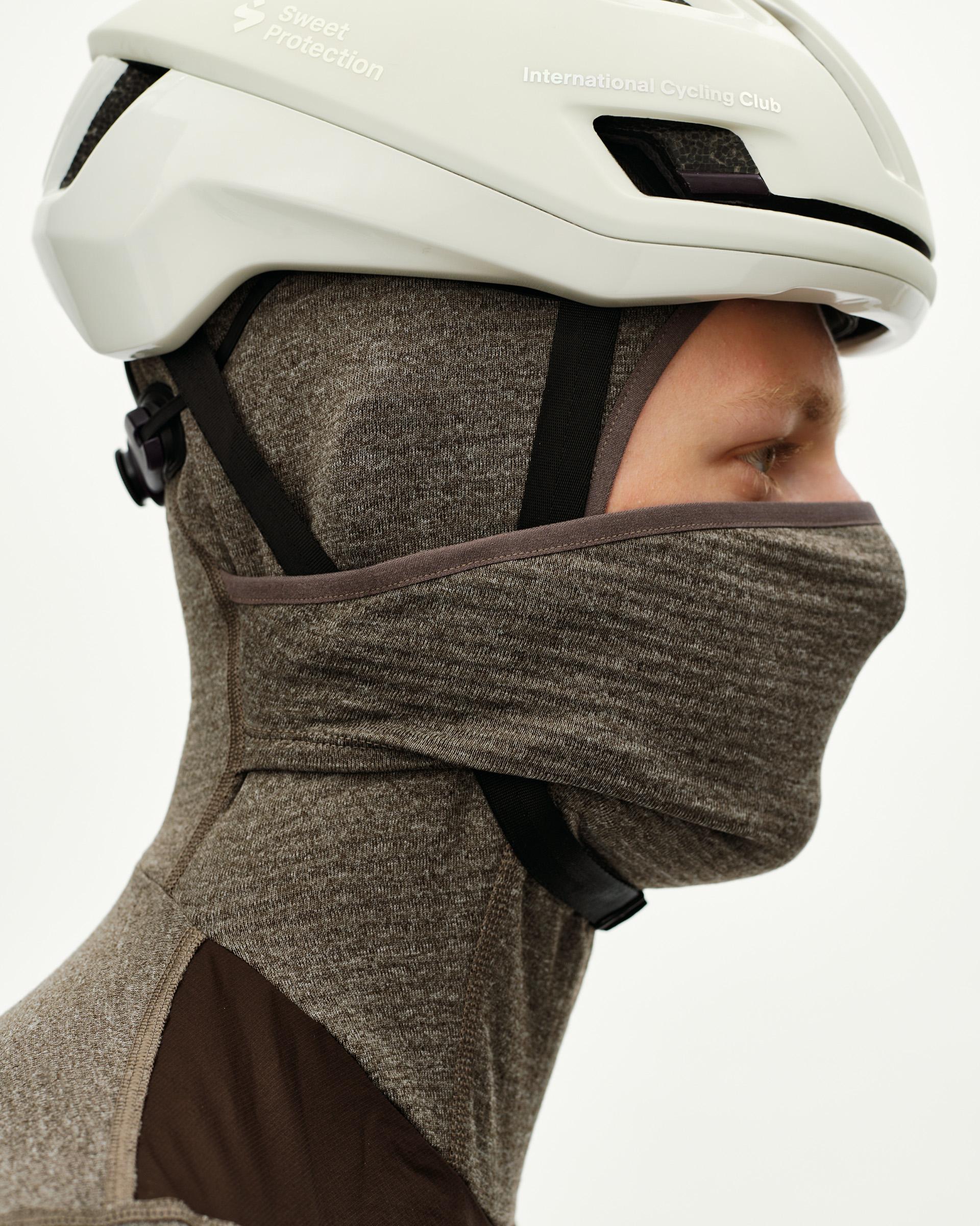 Dark Coffee brown Essential thermal hooded windproof cycling base layer, side view on model worn under helmet with hood up