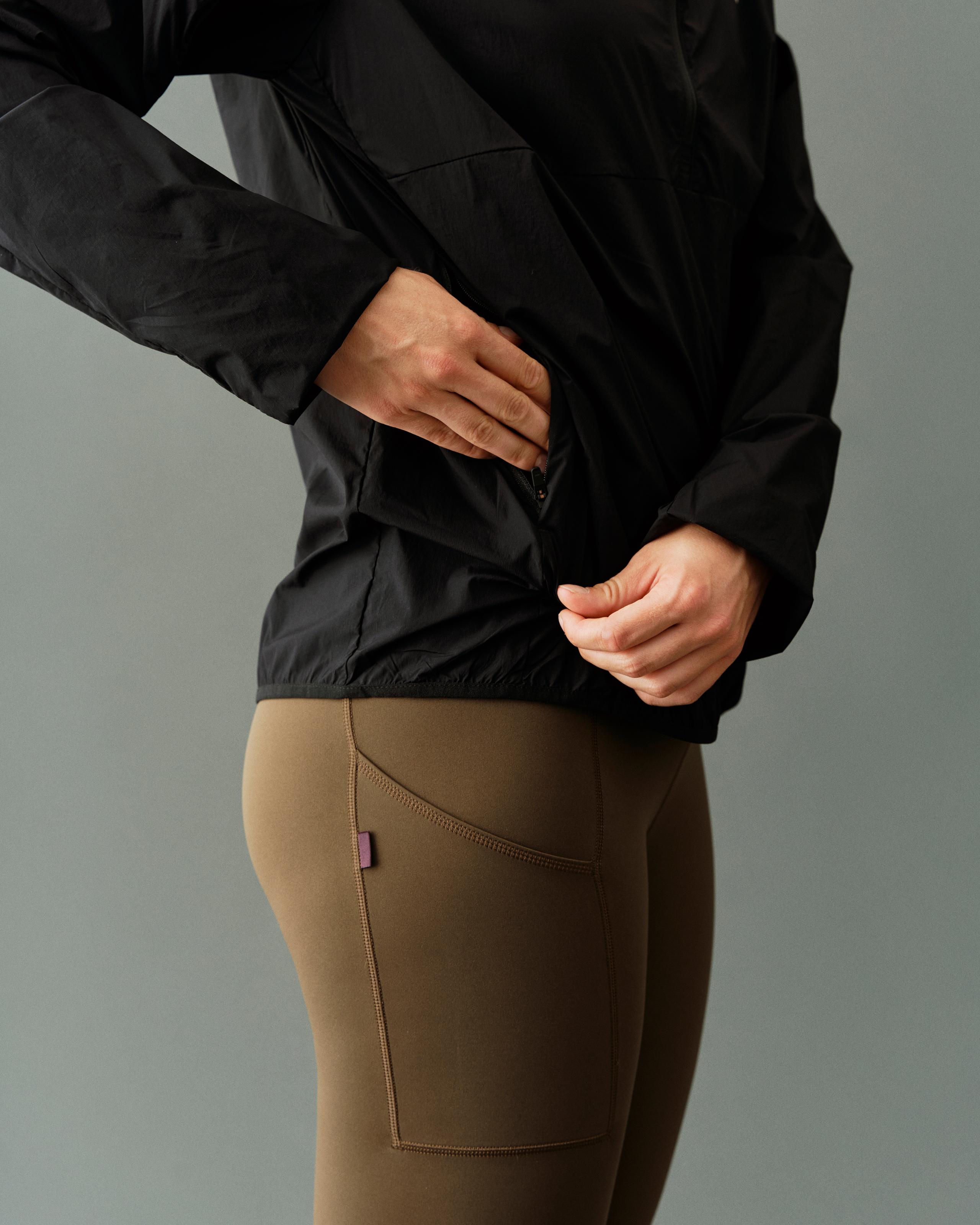 Black Balance Half Zip jacket on model showing zip pocket detail