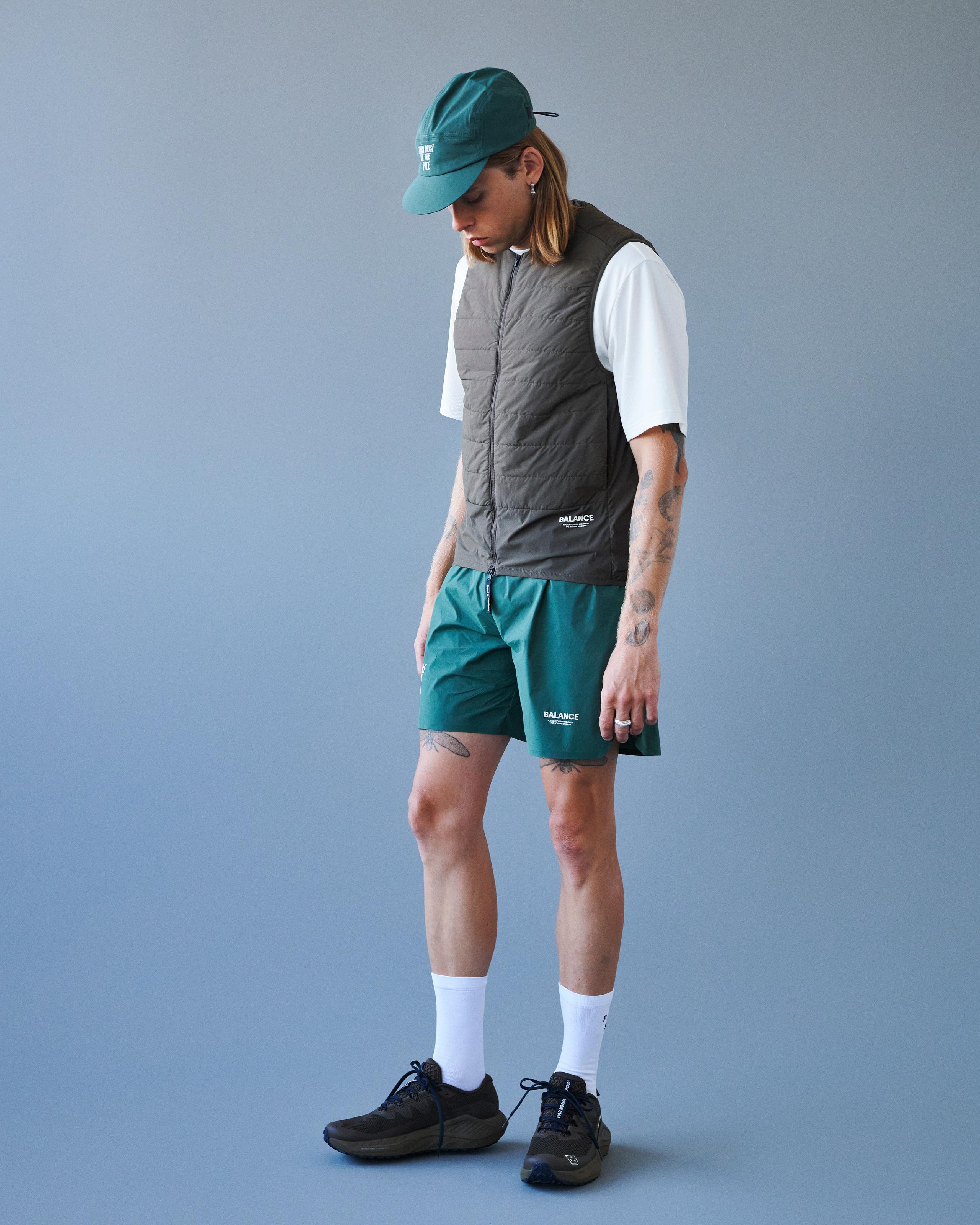 Green Balance shorts on model with elastic waistband and white logo