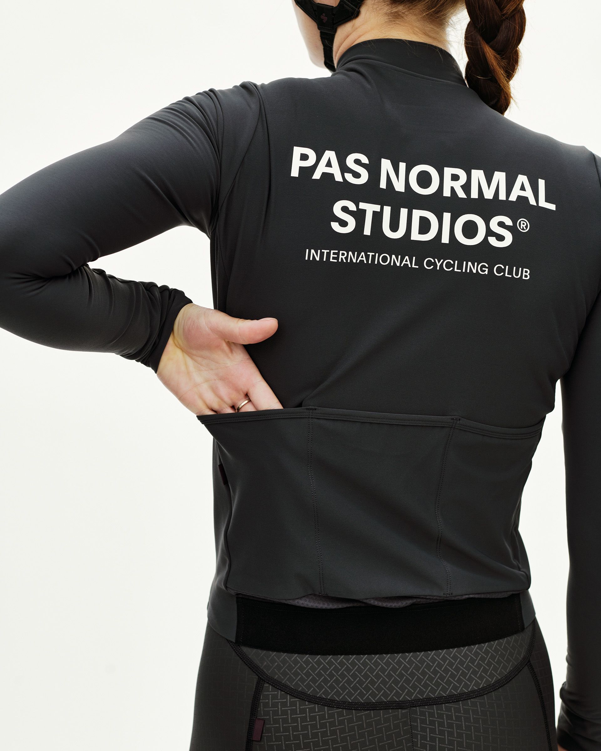 Dark Navy Mechanism women's long sleeve cycling jersey on model, rear view with white back print and rear pockets