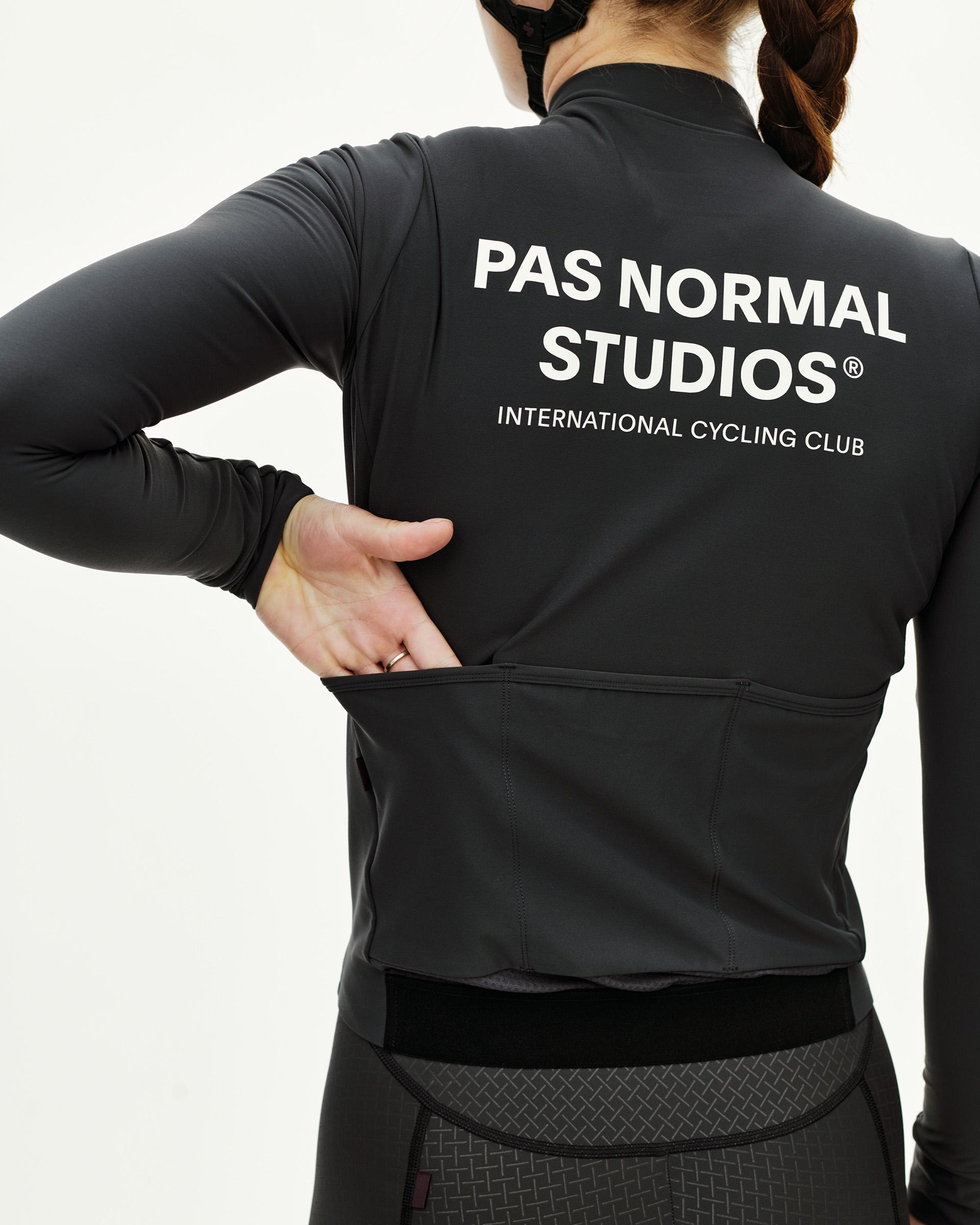 Dark Navy Mechanism women's long sleeve cycling jersey on model, rear view with white back print and rear pockets